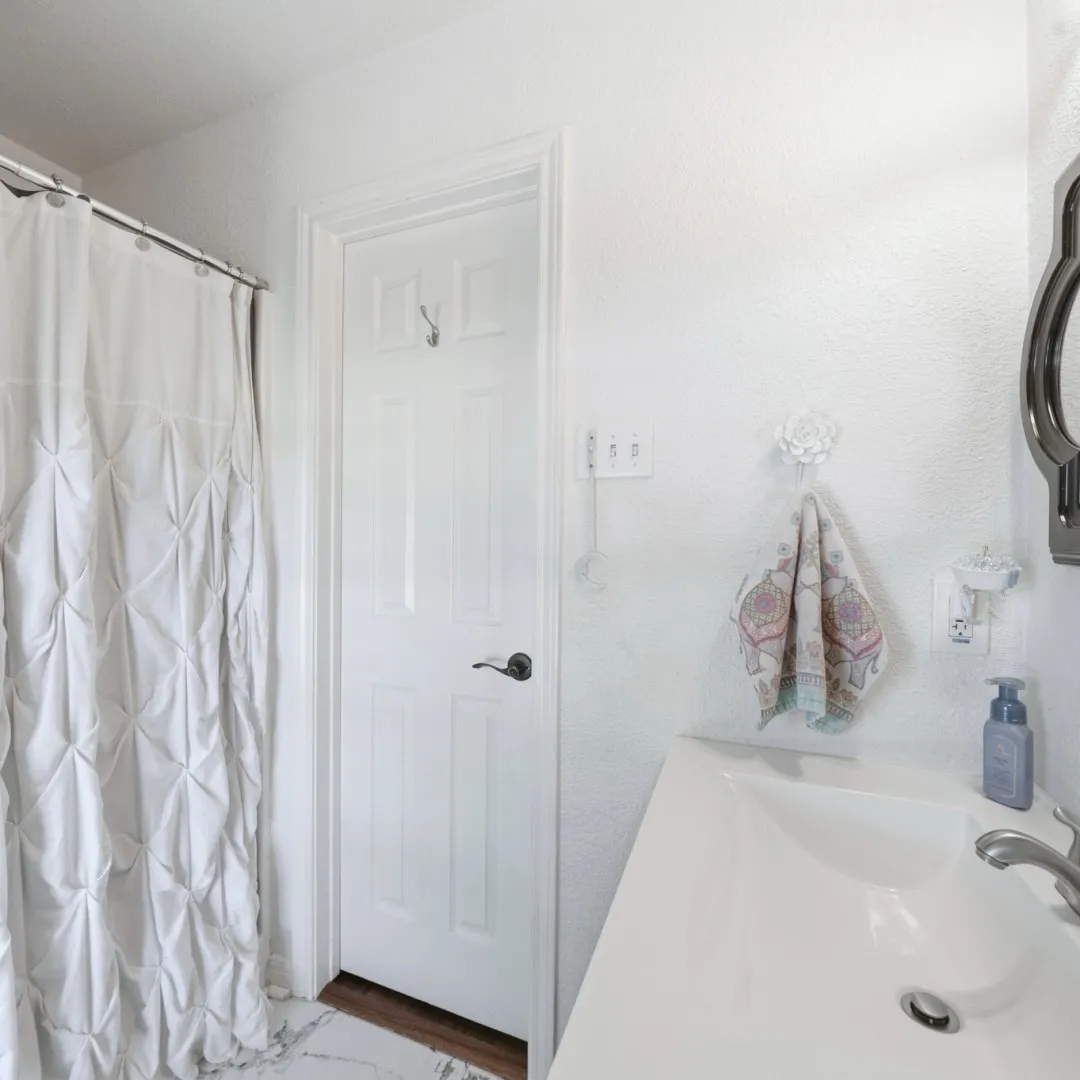 Bathroom vanity featuring an integrated sink with a chrome faucet