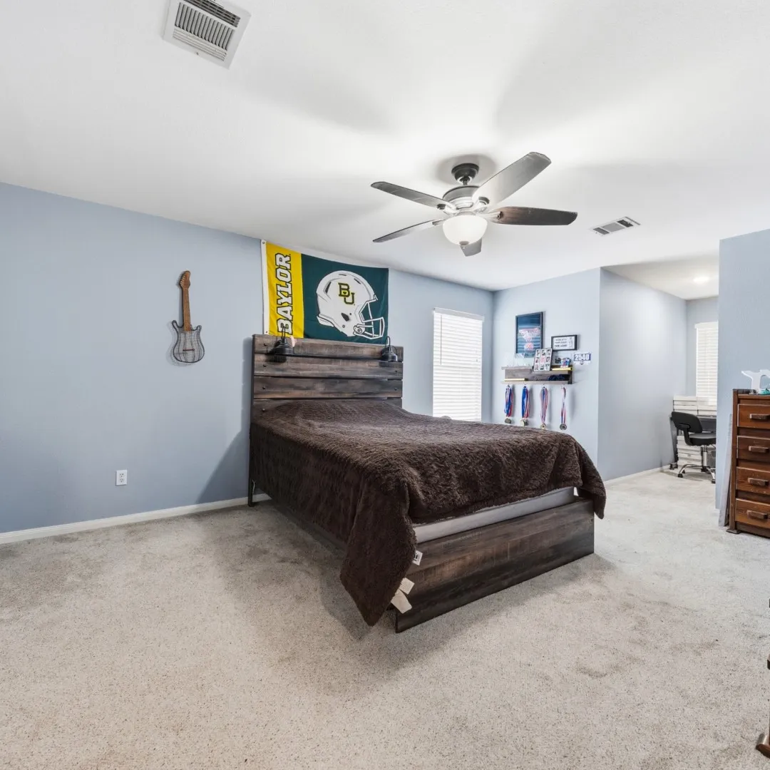 Bedroom featuring light-colored carpet flooring and light blue wall tones