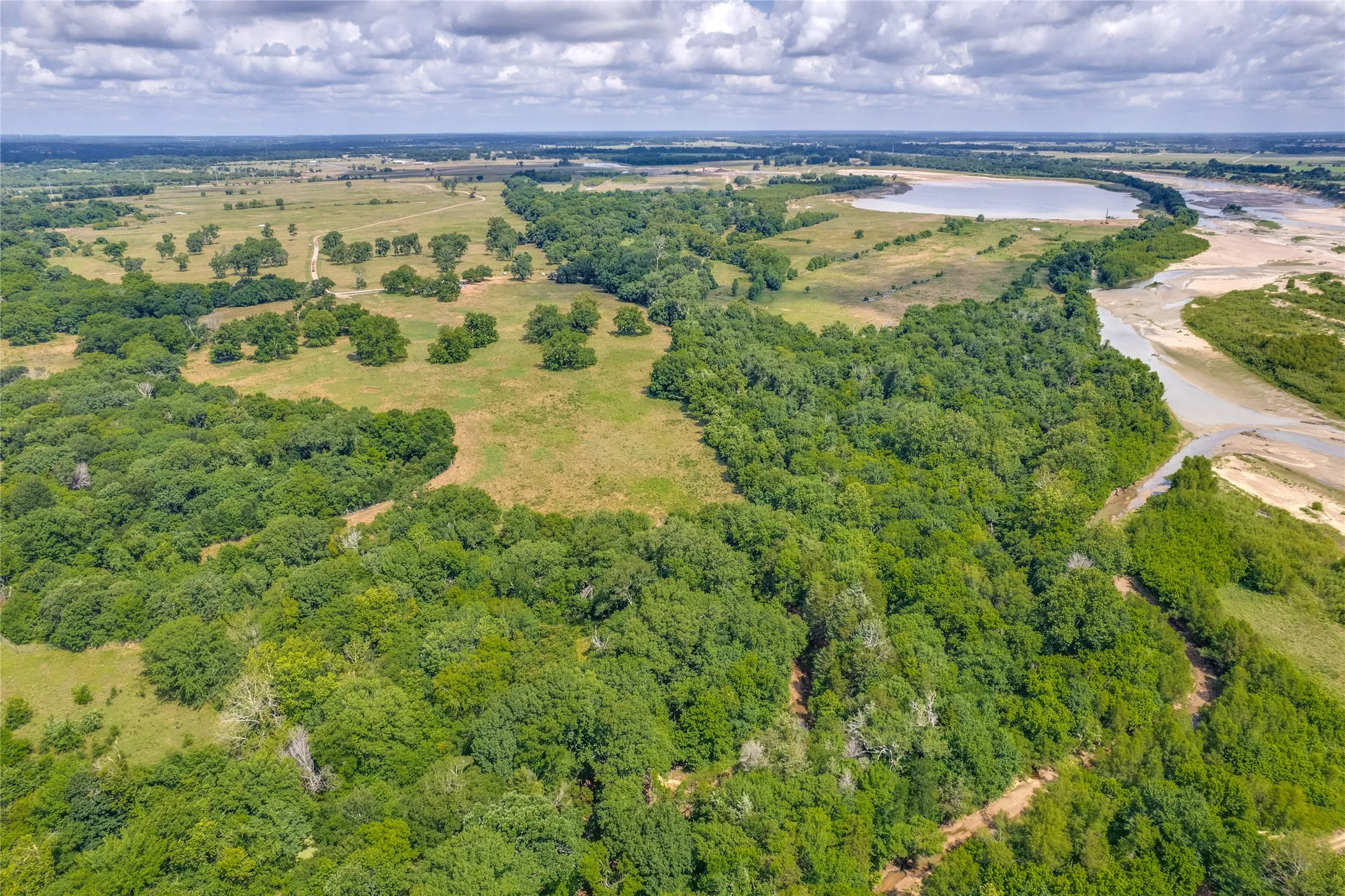 Aerial view from North property line above  Sand Creek looking West. Red River on the right.