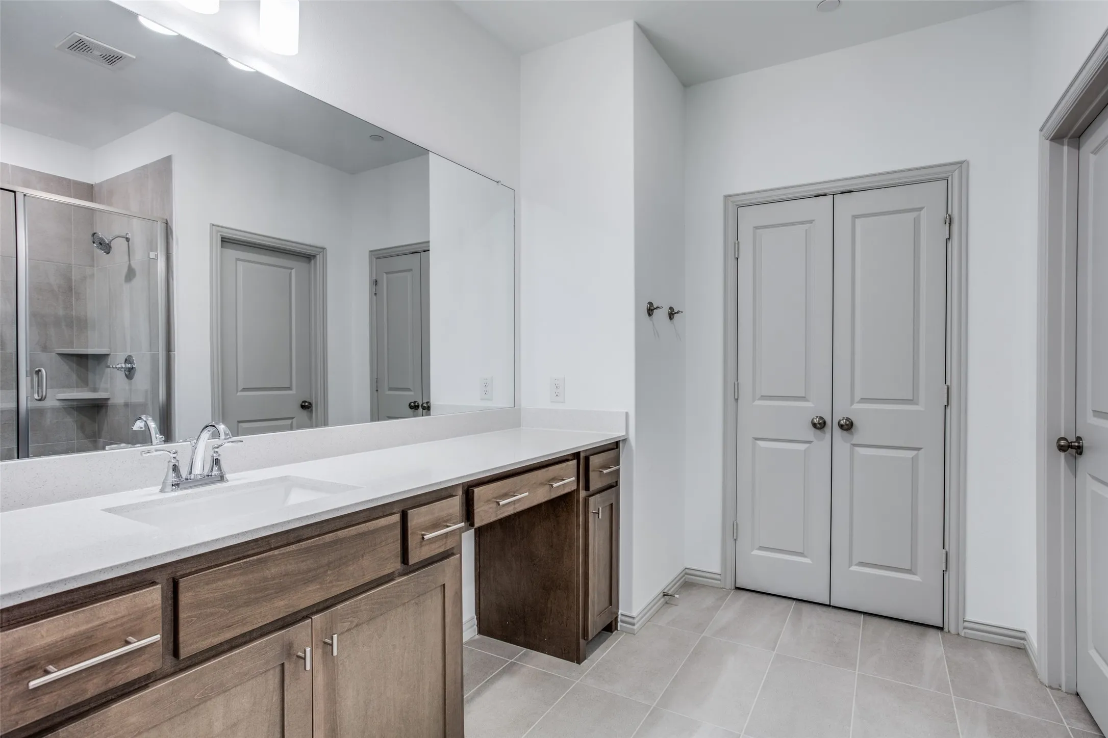 Dual vanities with decorative lighting.