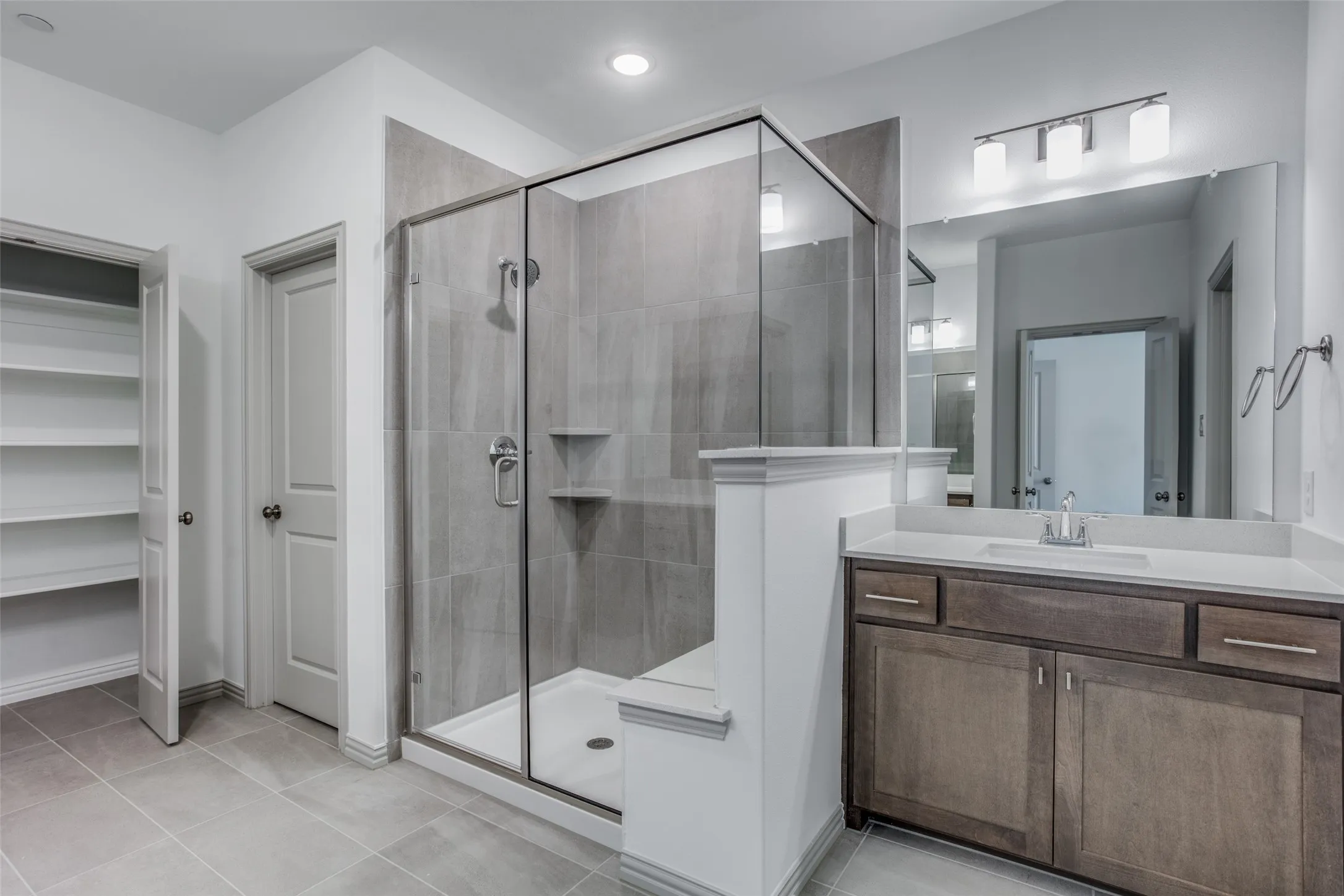 Spacious master with linen closet and separate vanities and huge shower with seat.