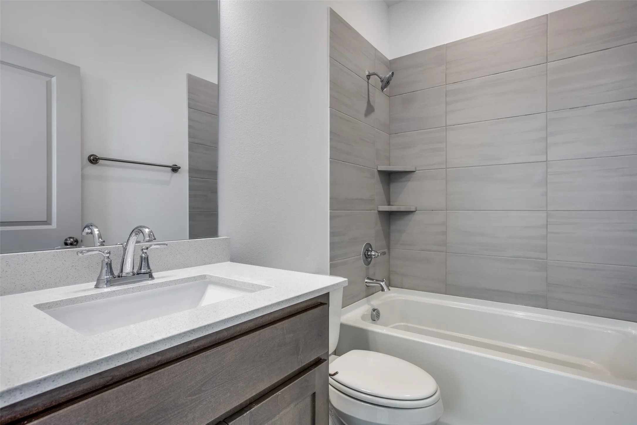 Secondary bathroom on level 2 with tiled shower. .