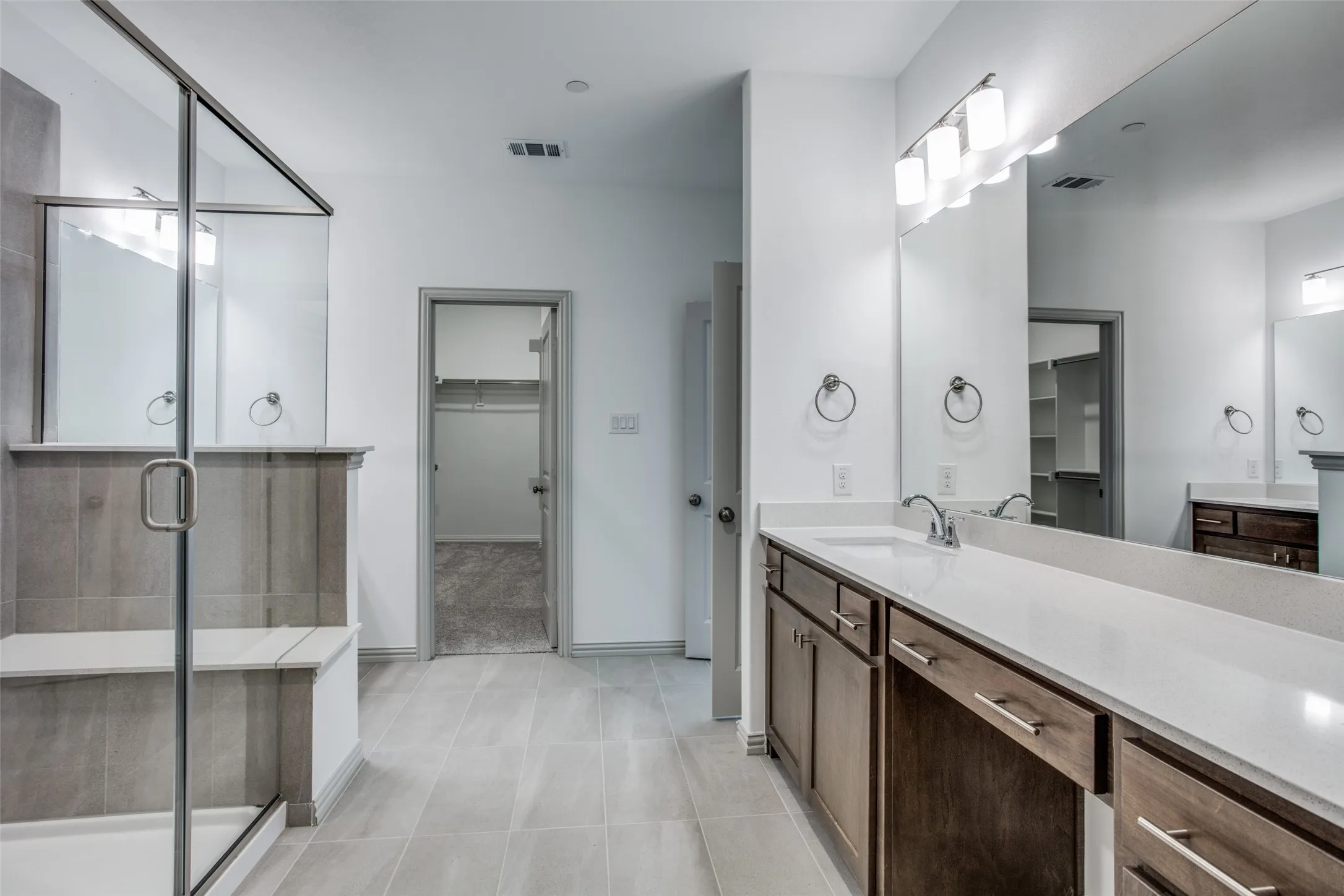 Luxury primary bathroom with huge walk in closet, linen closet, double sinks, oversized shower.