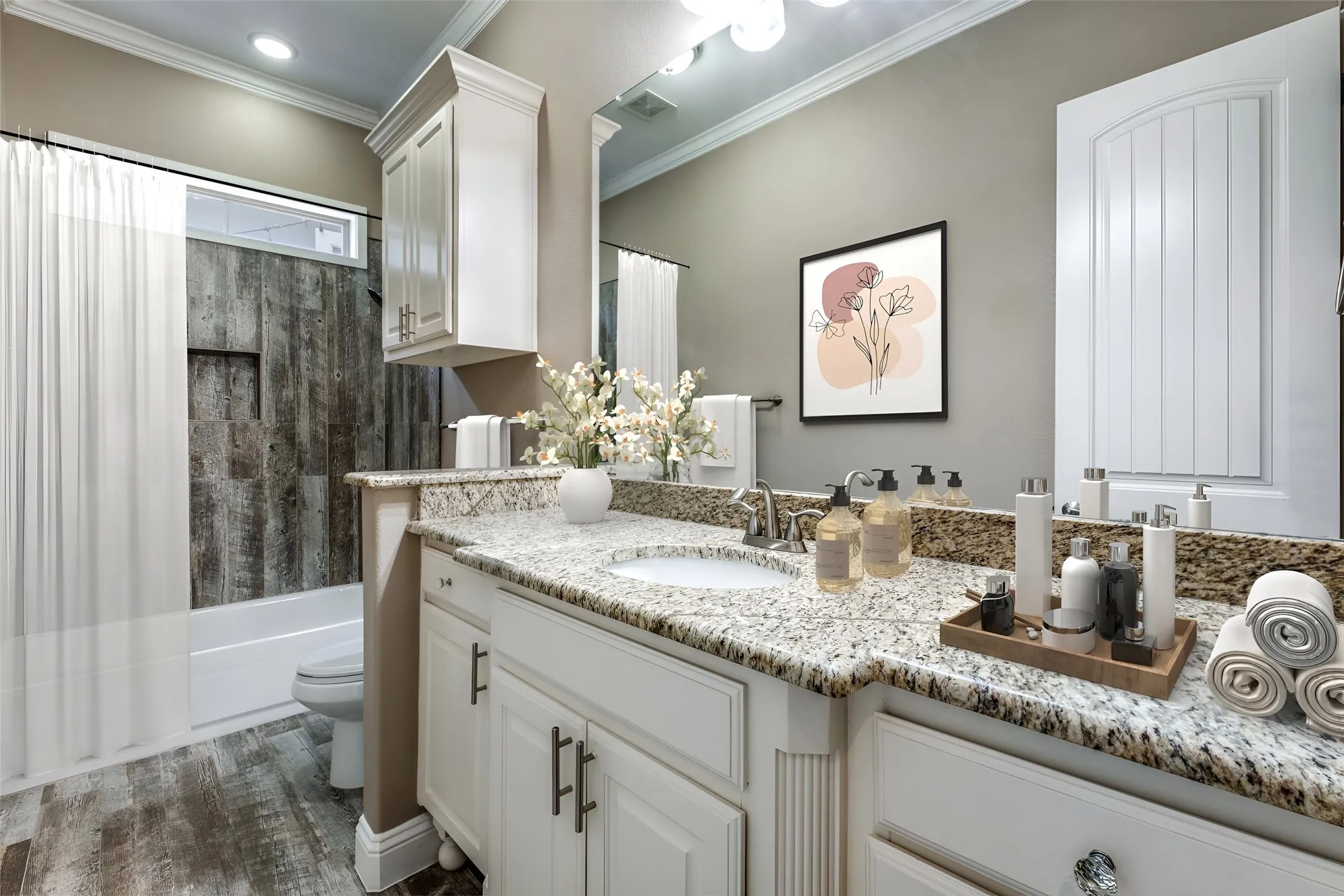 Bathroom featuring a vanity with a light-toned speckled countertop and undermount sink