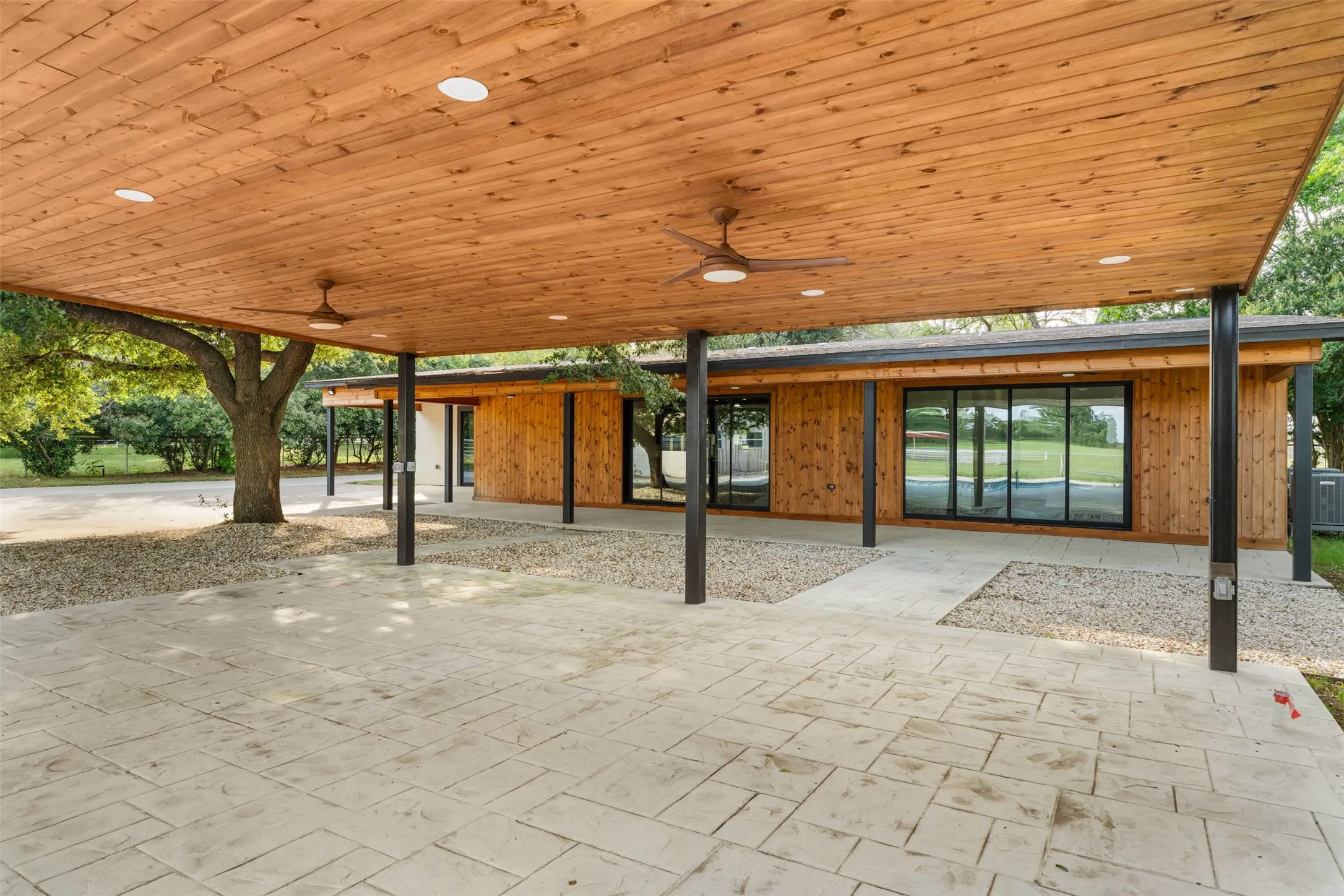 Backyard view of the house from the​​‌​​​​‌​​‌‌​‌‌​​​‌‌​‌​‌​‌​​​‌​​ pool