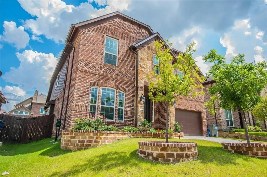 Two-story residence featuring a brick and stone facade