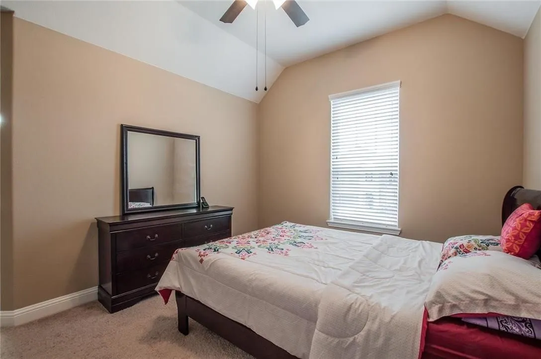 Vaulted ceilings featuring a ceiling fan and recessed lighting, neutral wall tones, and carpet flooring