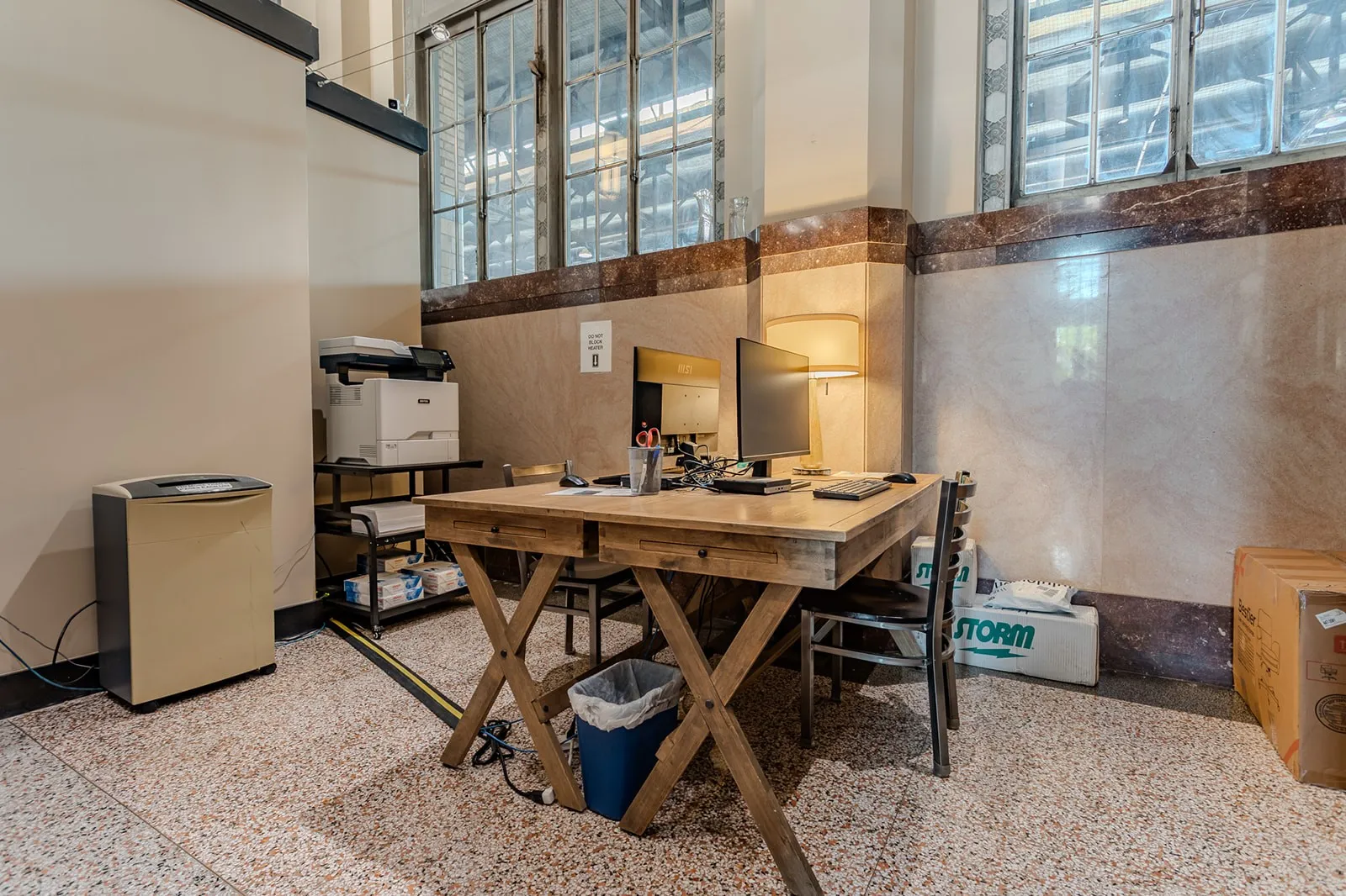 Office space featuring high ceilings, large multi-pane windows, and a terrazzo-style floor