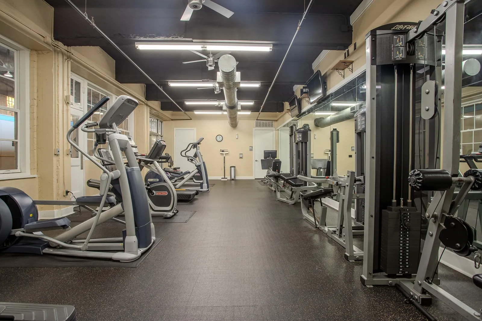 Dedicated fitness center featuring rubber flooring and extensive workout equipment