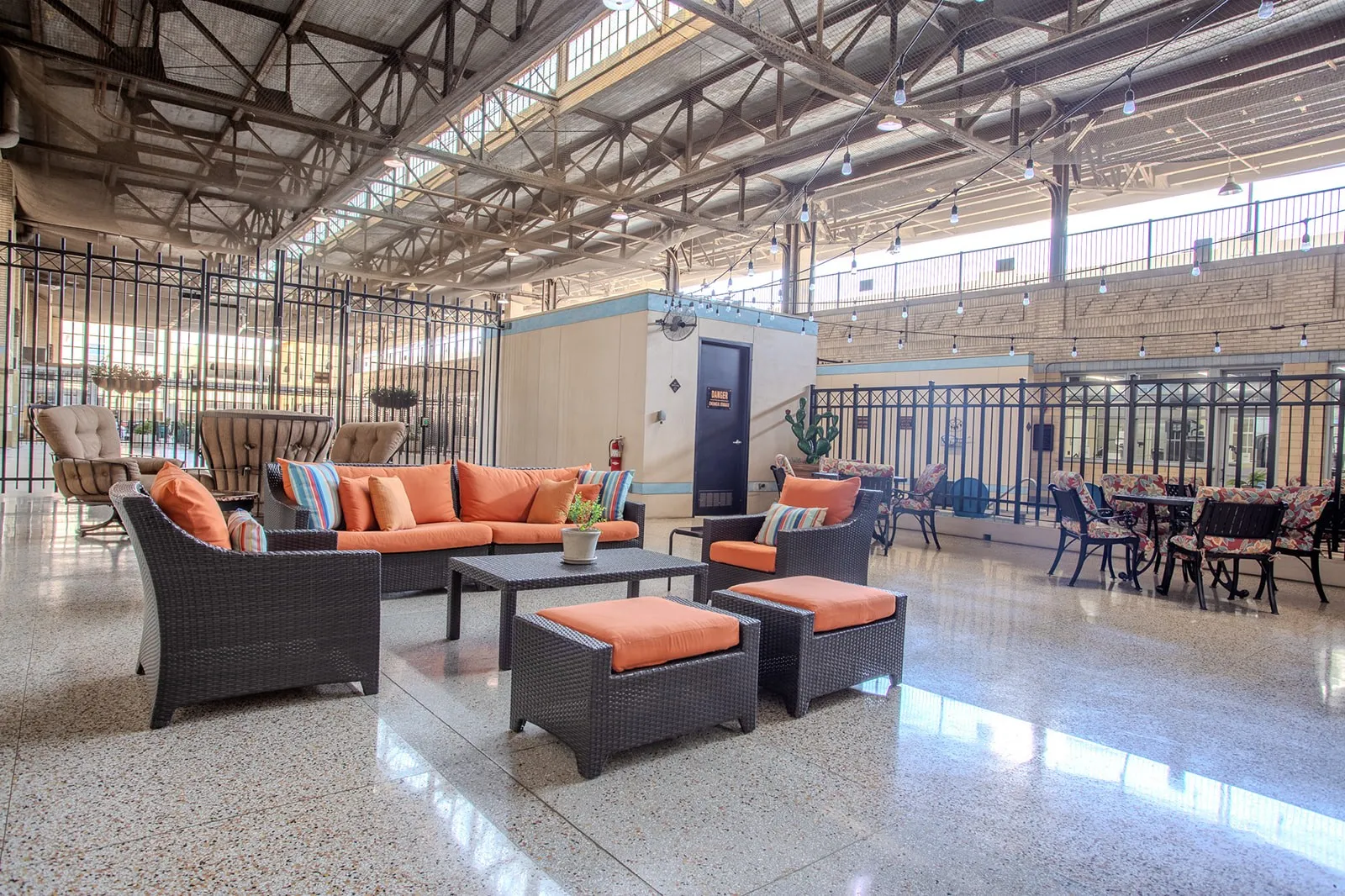 Expansive common area featuring a polished terrazzo floor and exposed structural ceiling with skylights