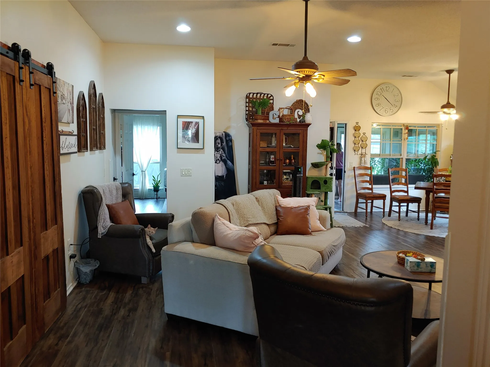 Spacious room featuring wood-finish flooring, recessed lighting, and a prominent ceiling fan