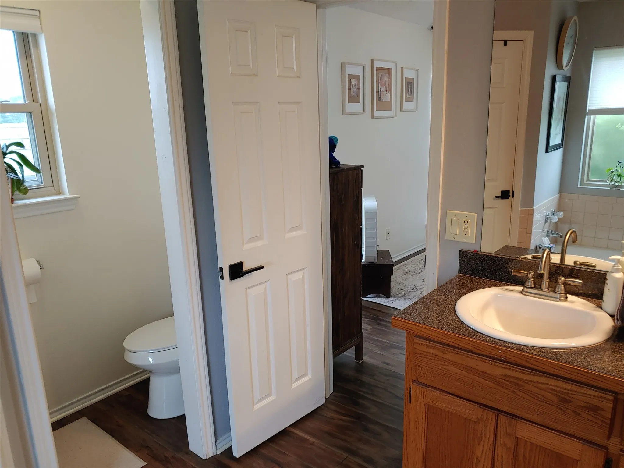 Bathroom vanity featuring a granite-finish countertop with an undermount sink and a polished chrome faucet