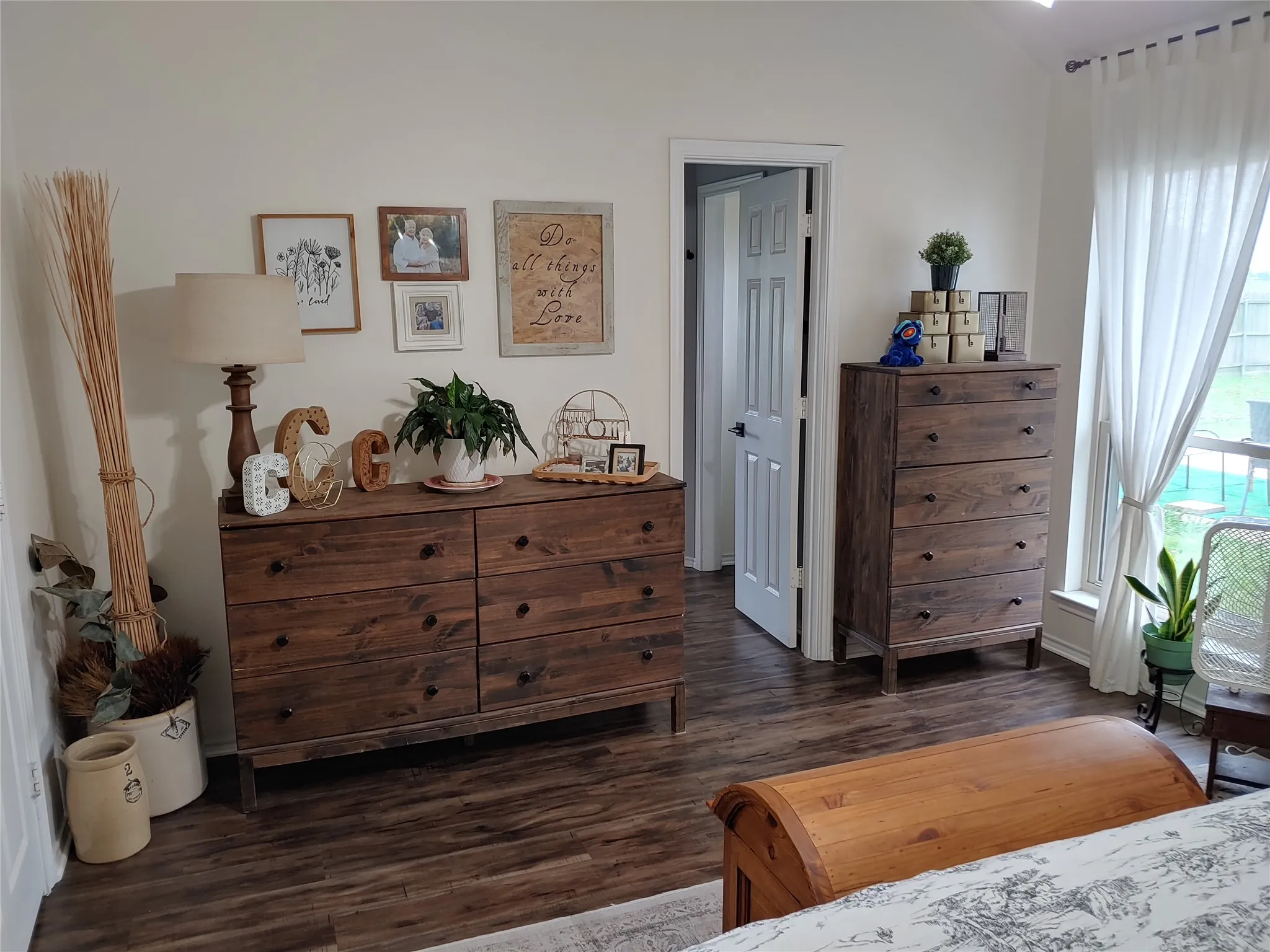 Interior space featuring wood-finish flooring, white walls, and a white interior door