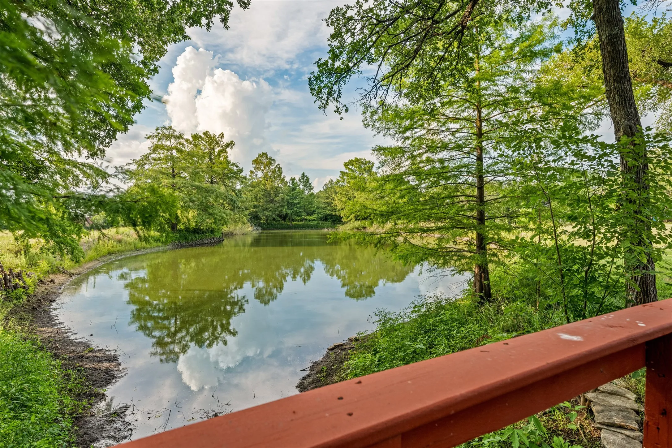 Back of property with a private pond
