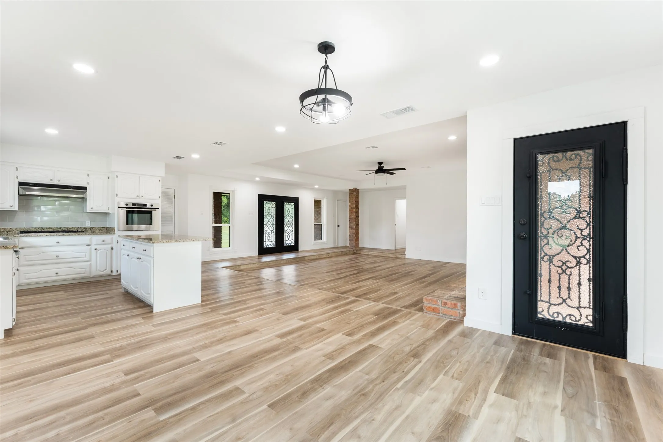 Back door, view of open kitchen and concept Living Room