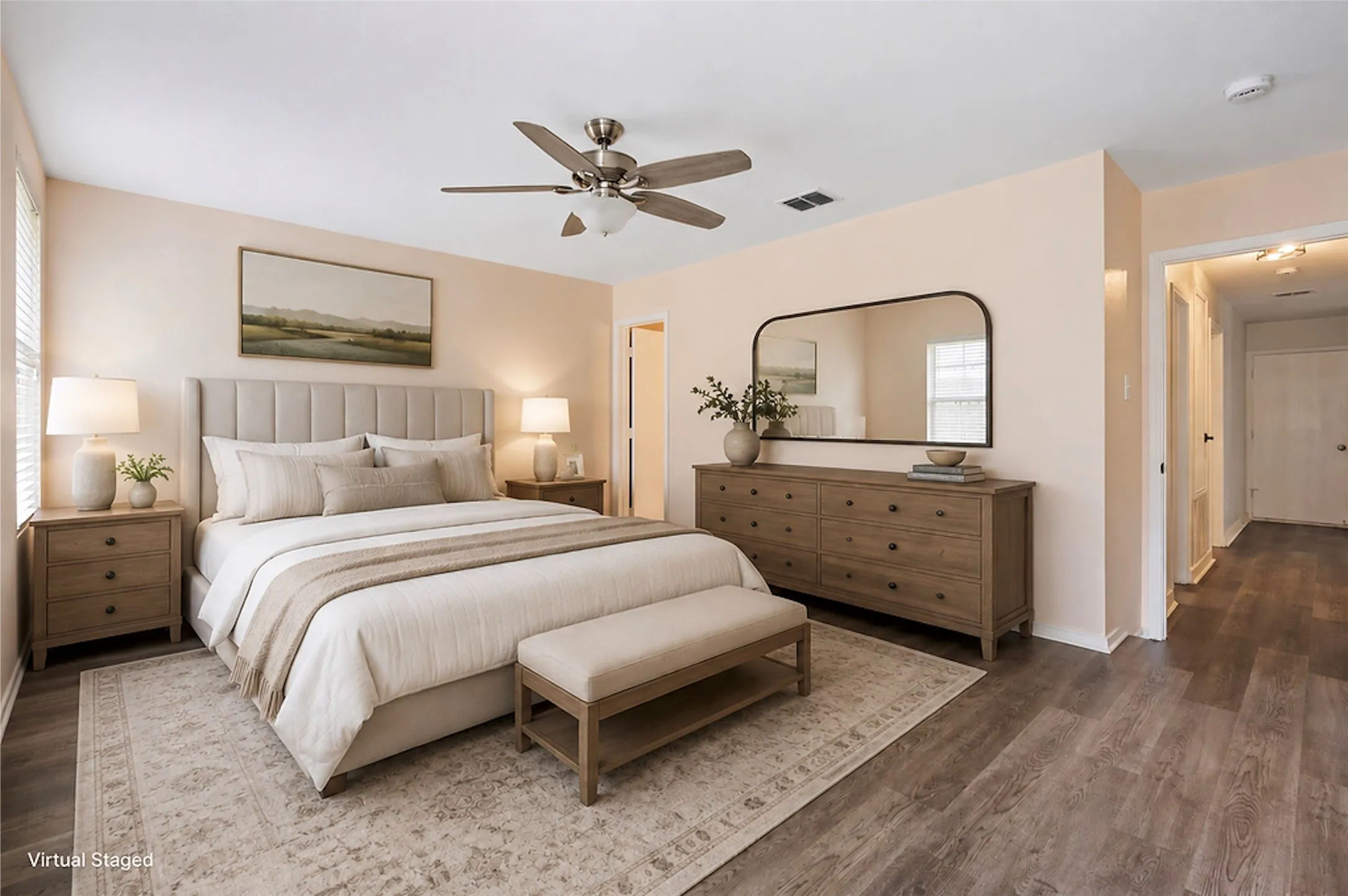 Spacious interior featuring wood-finish flooring, a ceiling fan with integrated lighting, and light-toned walls