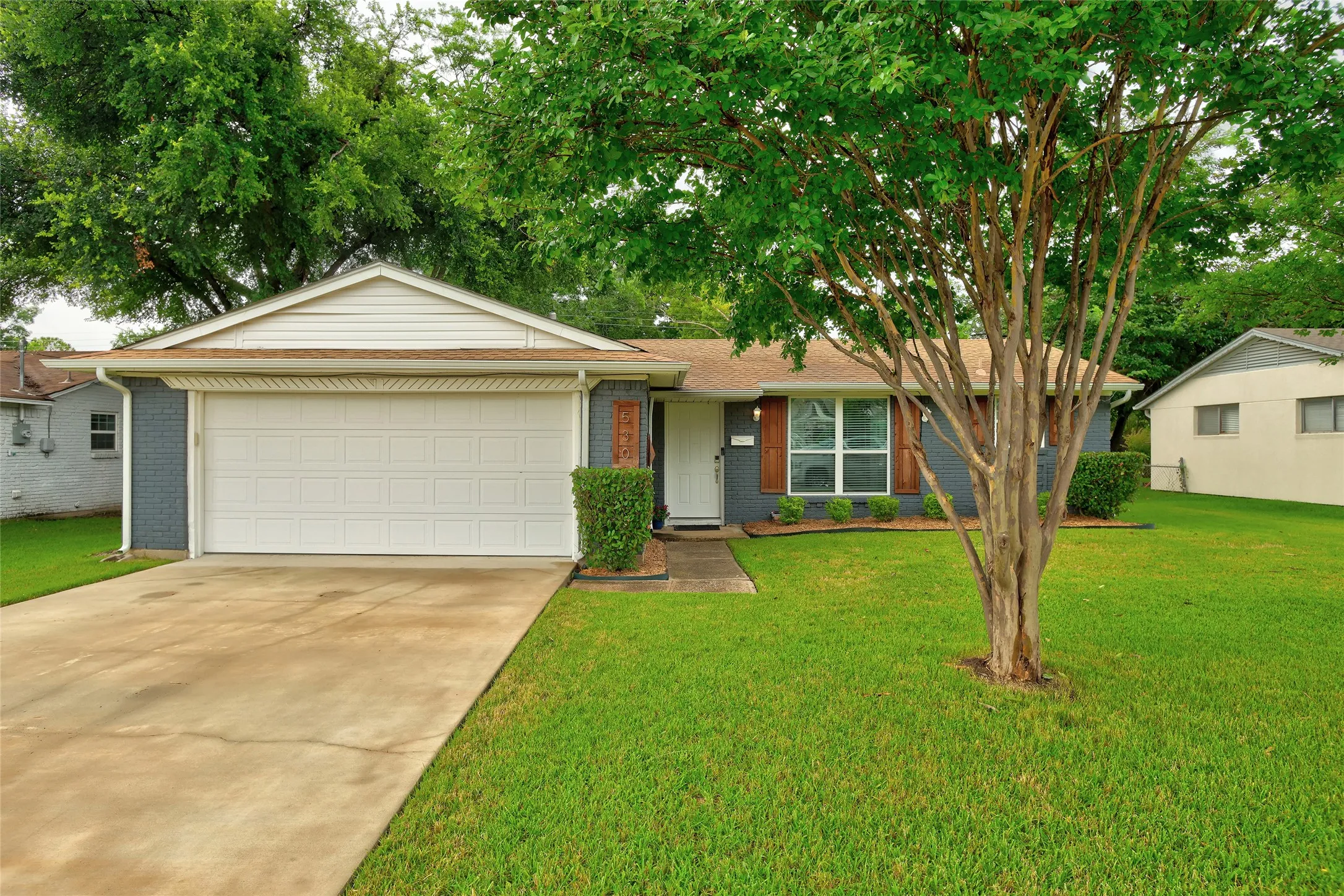 
check out the newly poured concrete driveway and the rare two car garage