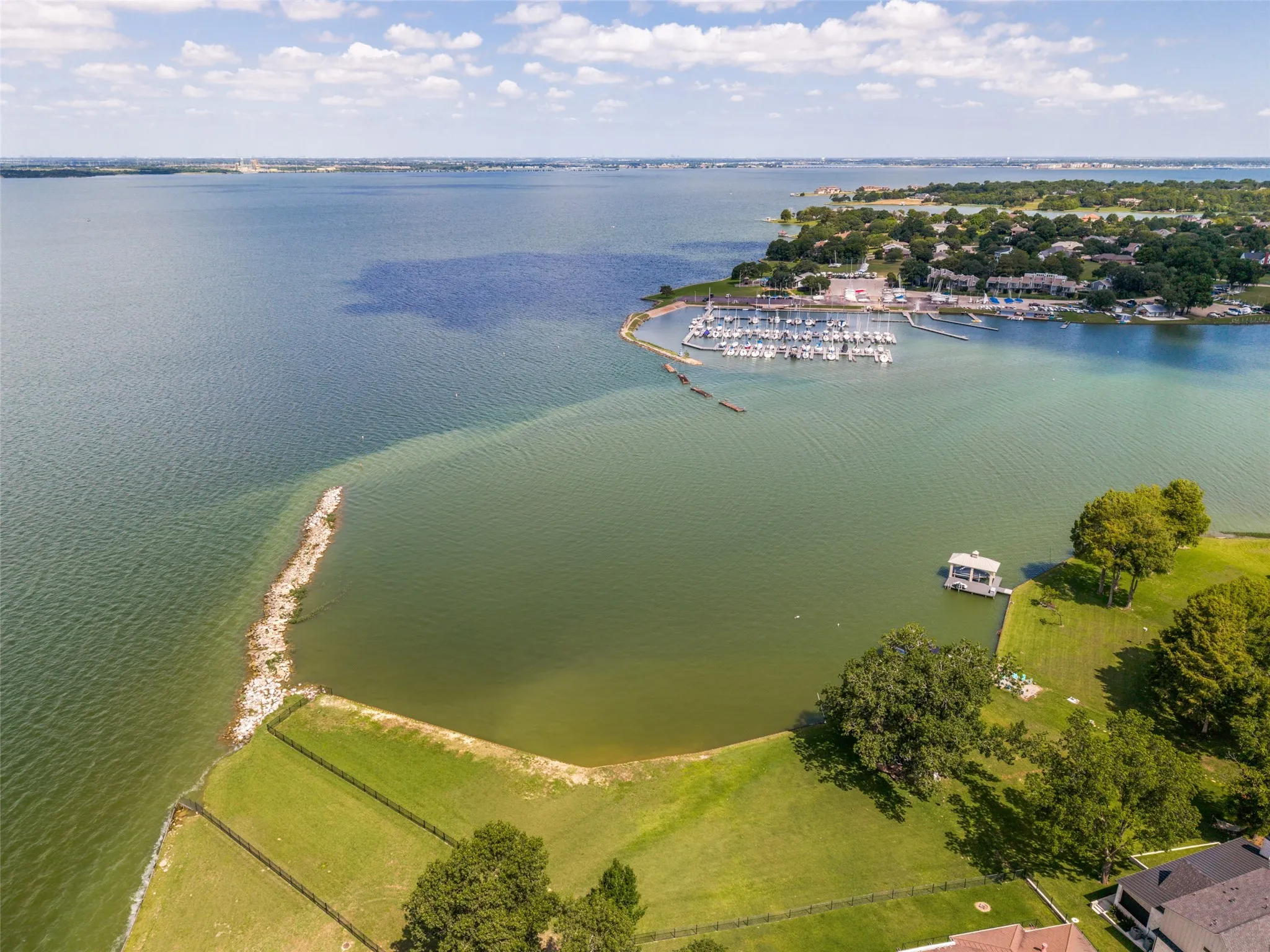 Water Take in for kayaking and wakeboard - Expansive waterfront property featuring a boat dock with covered slip, mature trees, and direct water access