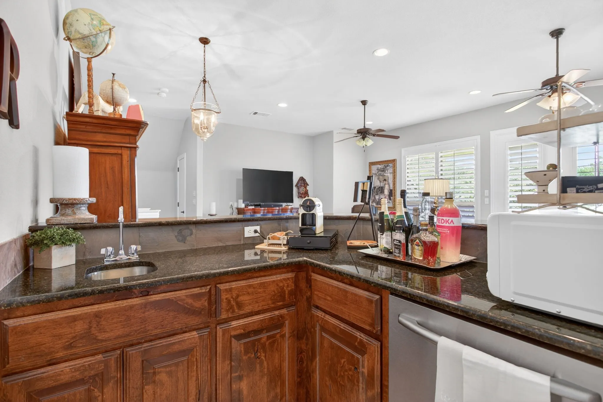 Upstairs wet bar with sink, dishwasher and undercounter drinks fridge.