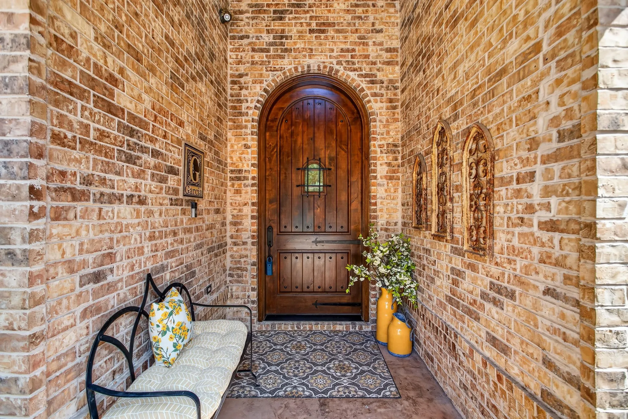 Covered front porch with an elegant front door welcomes you home.
