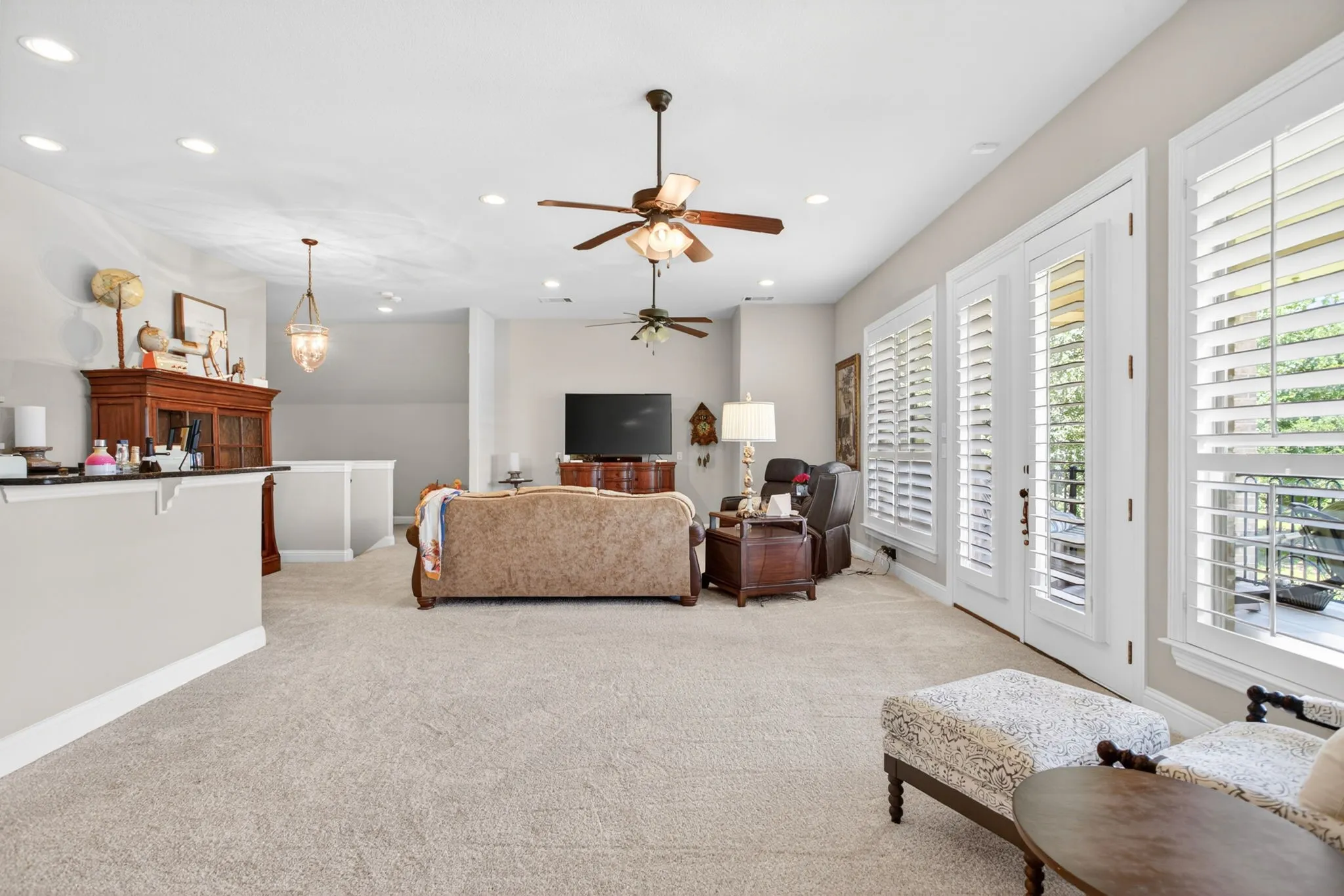This light filled room is a great place to relax.  The doors lead to the large balcony.