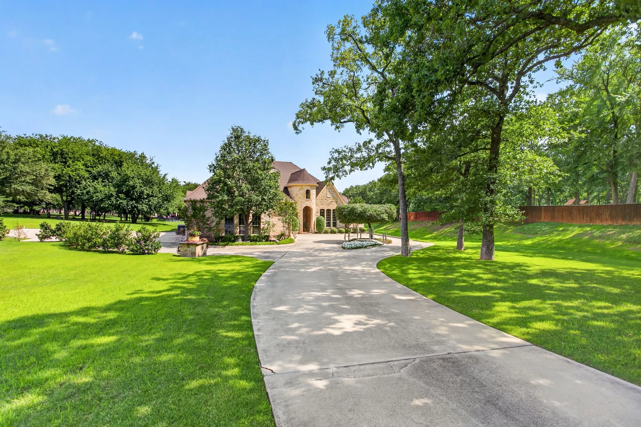 Long driveway has a circular drive in front and a large parking pad on the East side of the house.