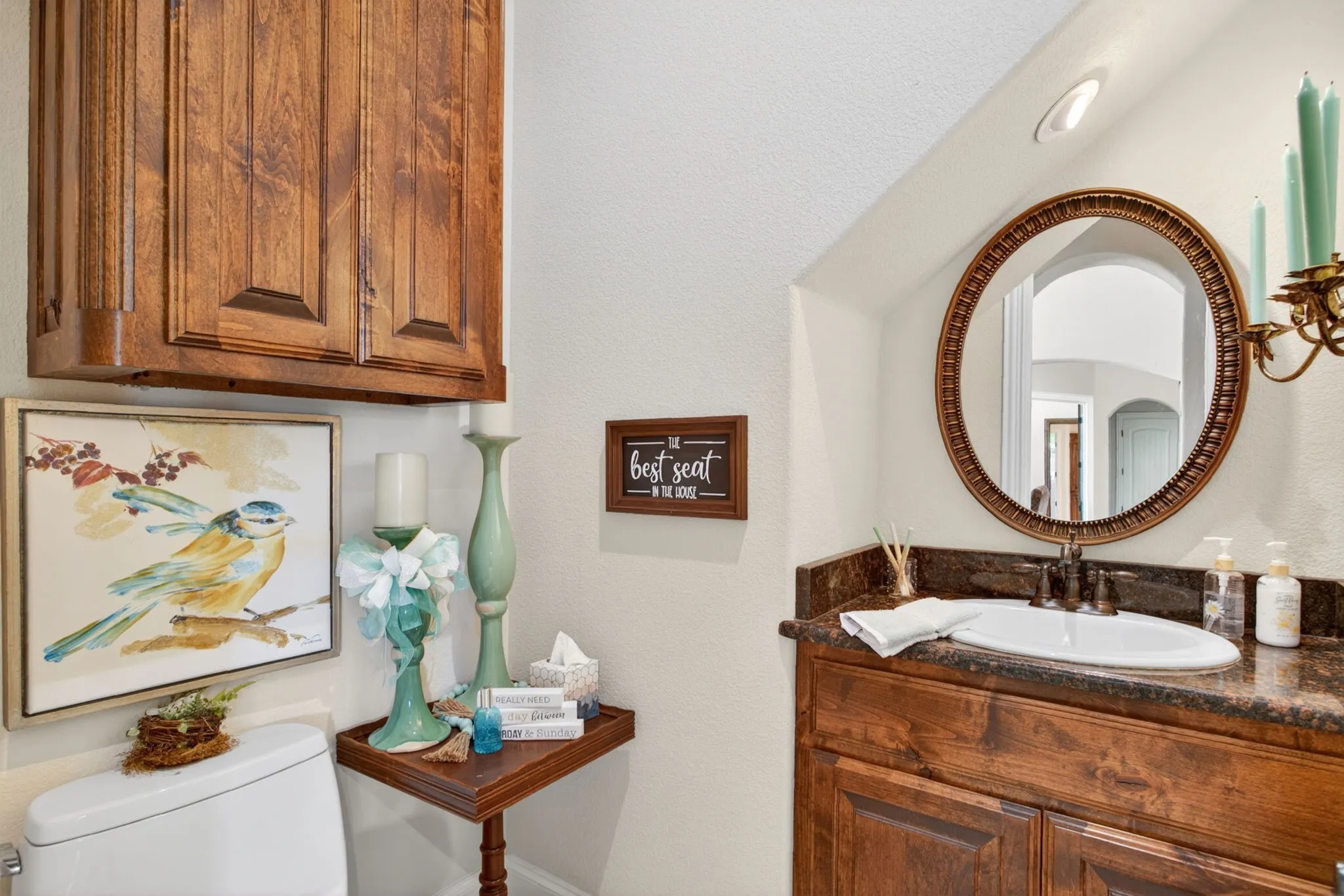 Half bath is downstairs in the hallway behind the kitchen area that leads to the laundry room and garage.