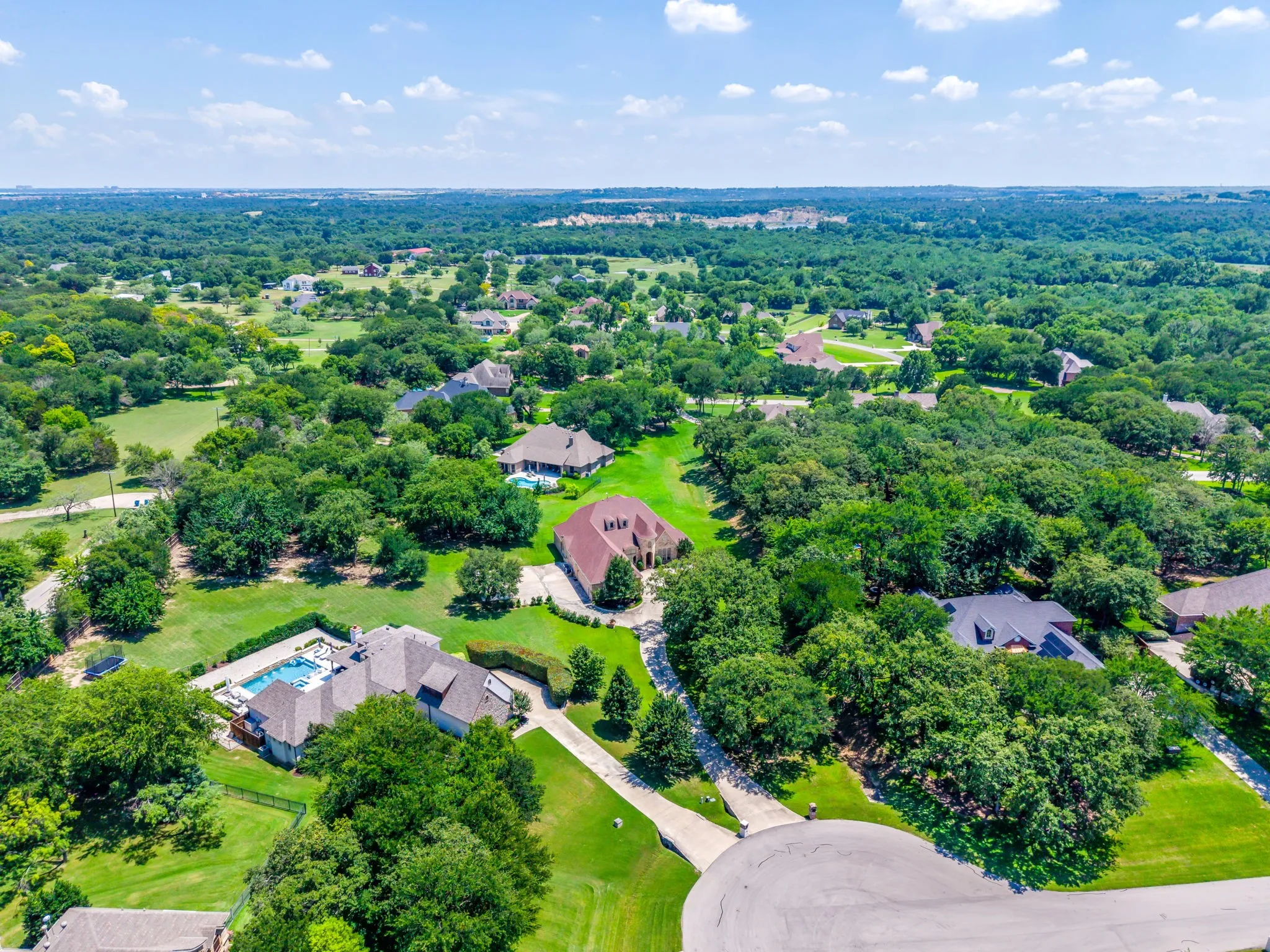 Aerial photo of the property in the center of this lovely neighborhood of 1+ acre lots surrounded by beautiful trees.