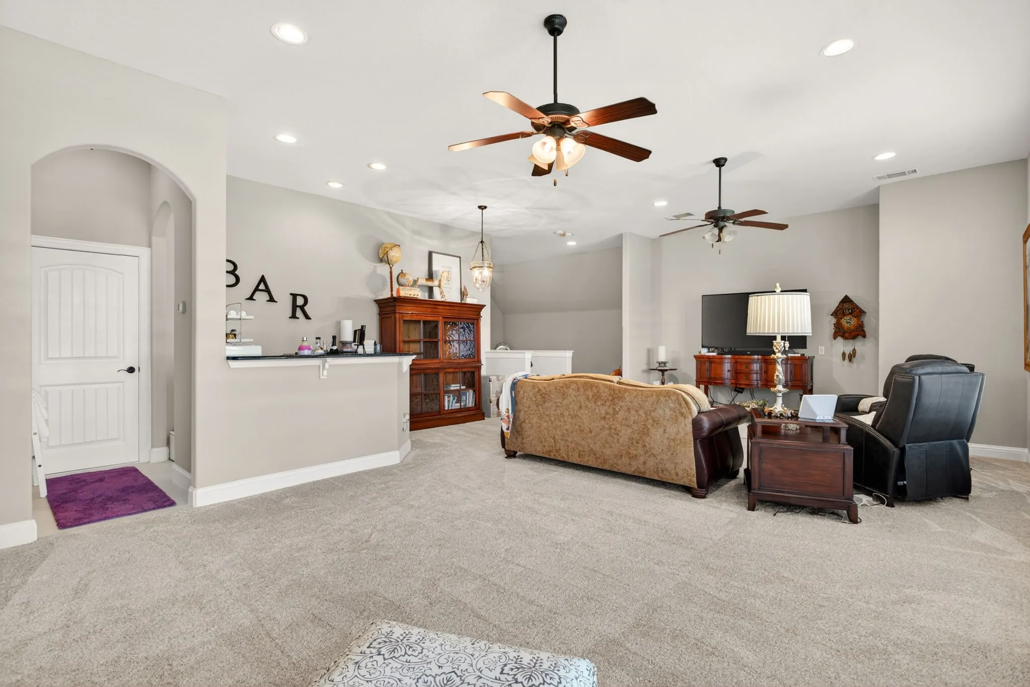 Upstairs you will find this huge living room/game room with a full wet bar.