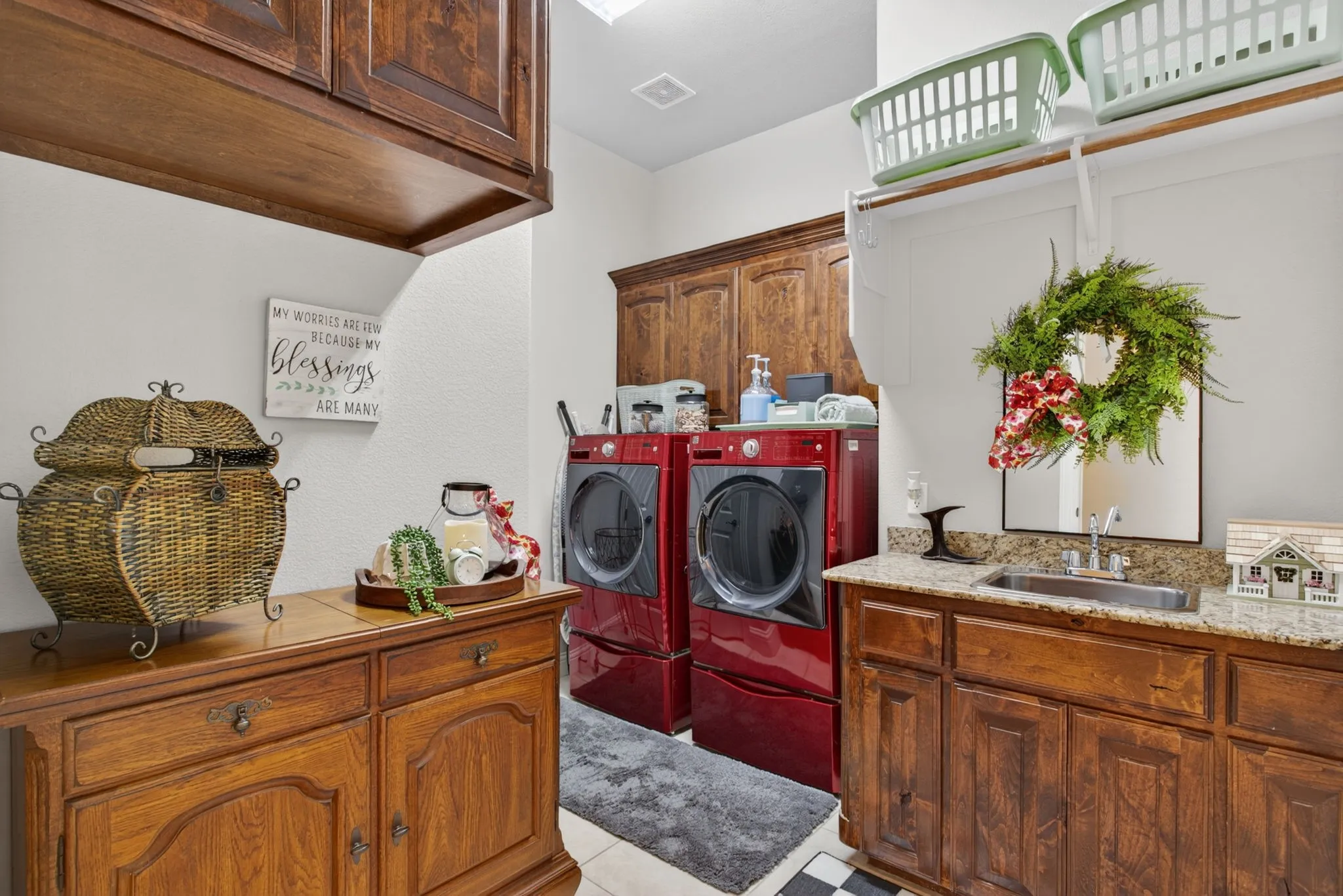 Downstairs laundry room with sink and room for full size washer and dryer has loads of storage!