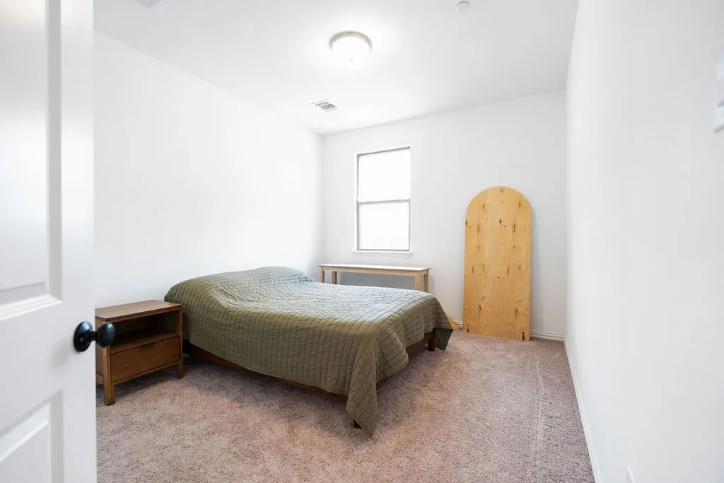 Carpeted room featuring a window and white walls