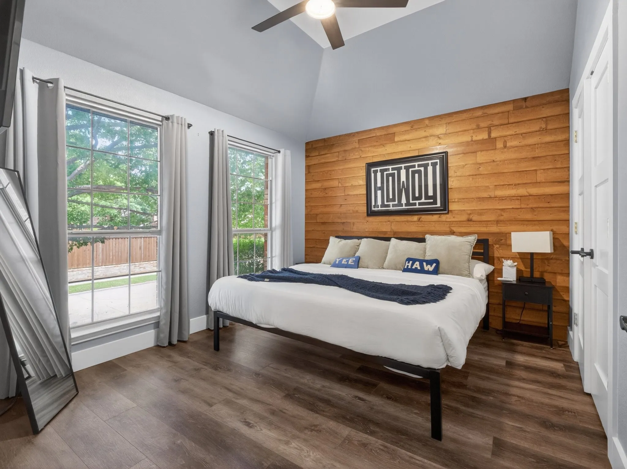 Vaulted ceiling bedroom with a wood-plank accent wall