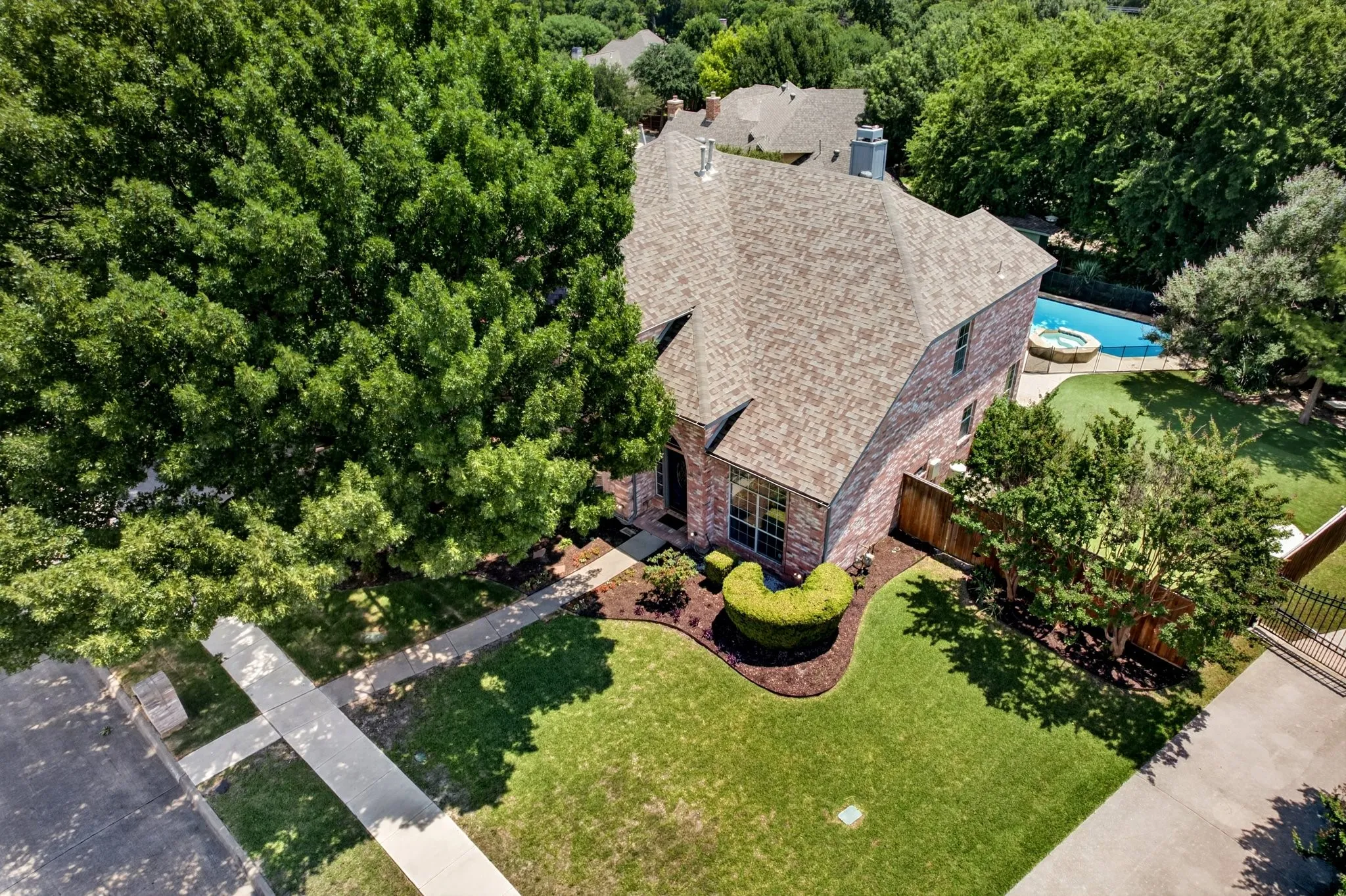 Brick exterior residence with a shingle roof