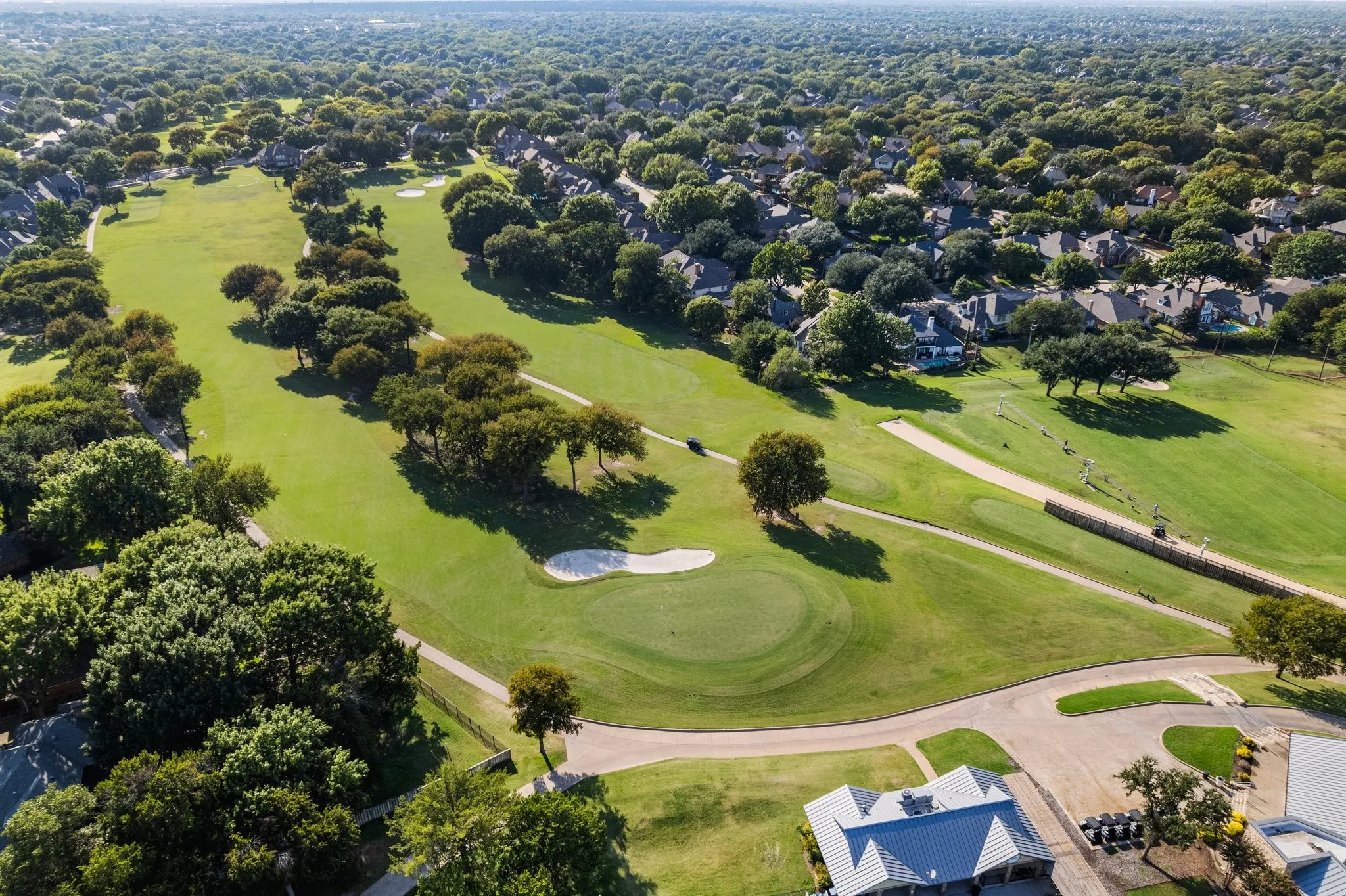 Expansive golf course setting featuring multiple greens and fairways