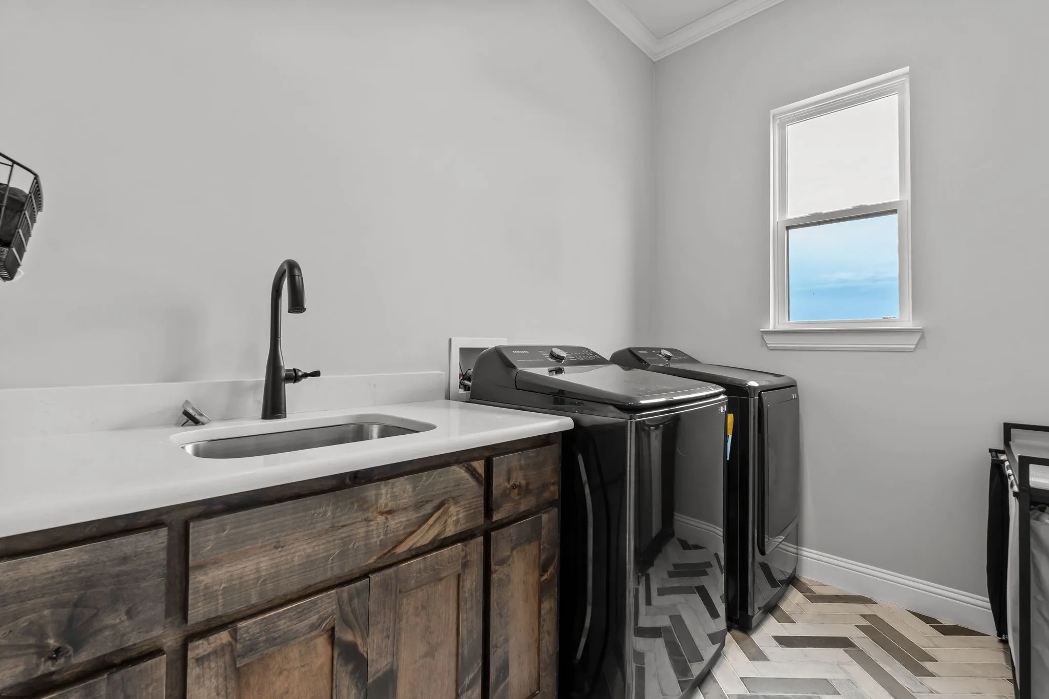 Good size laundry room with cabinet storage and sink