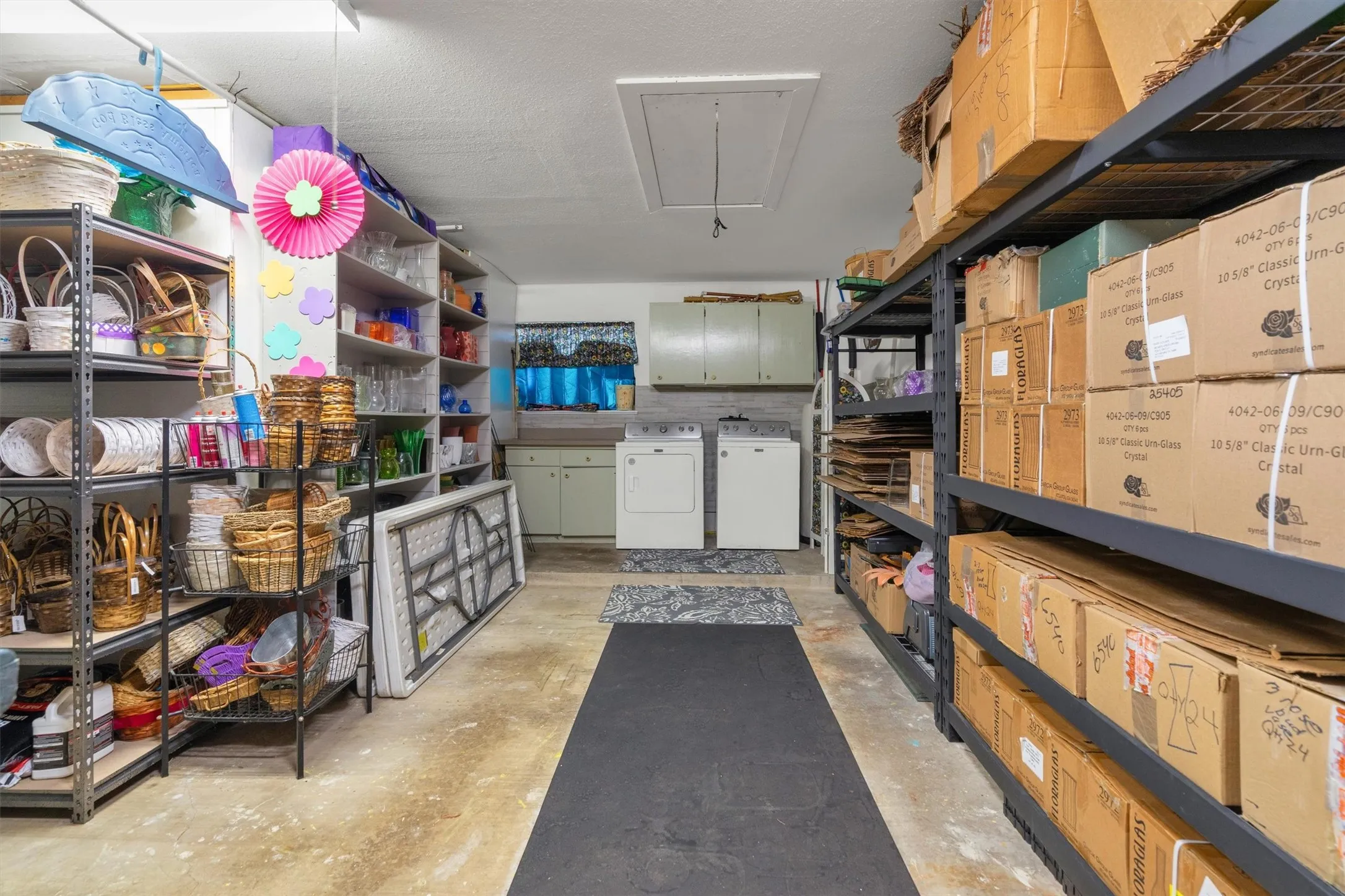 Dedicated laundry area with side-by-side appliances, a utility sink, and wall-mounted cabinetry