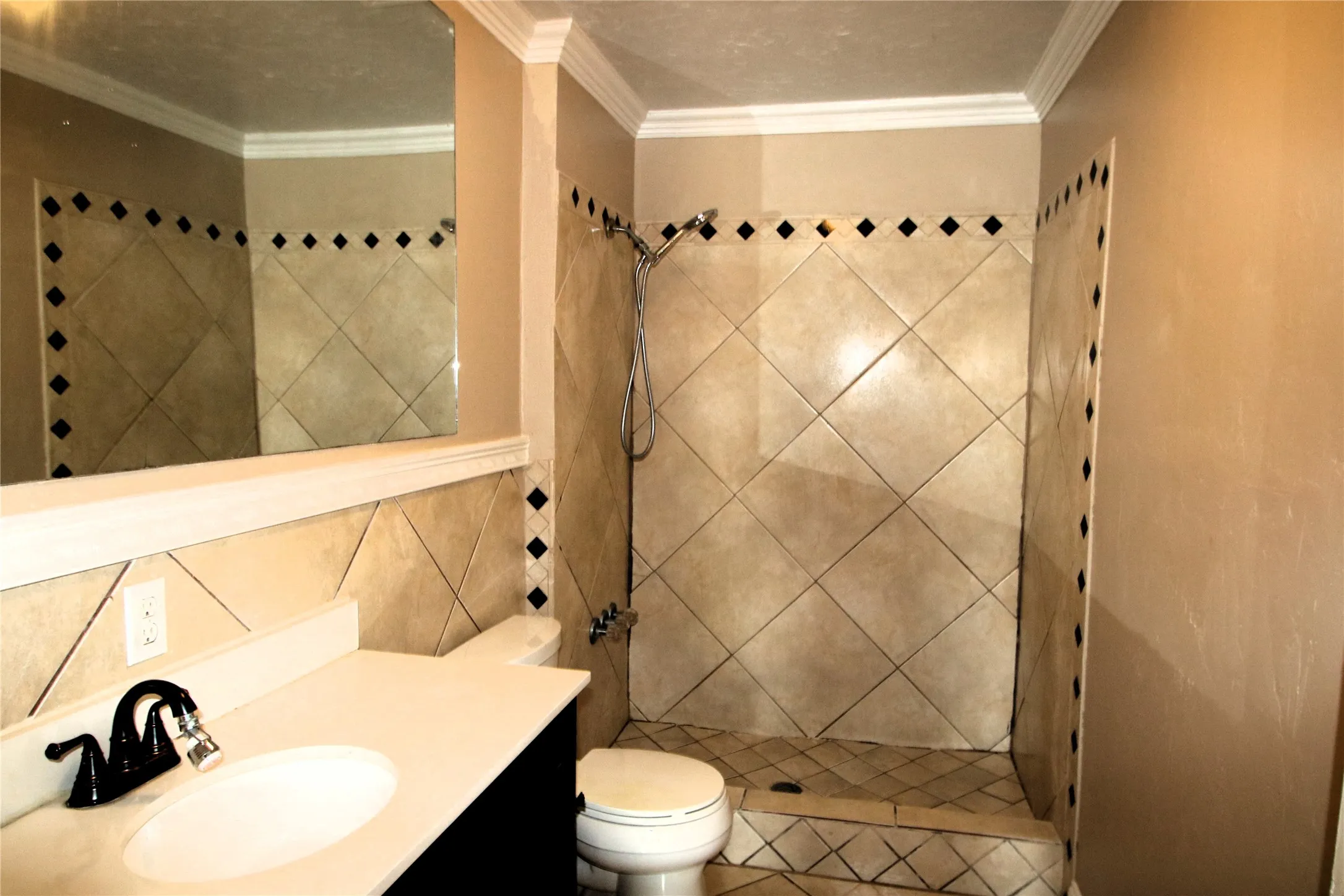 Custom tiled shower with a handheld showerhead