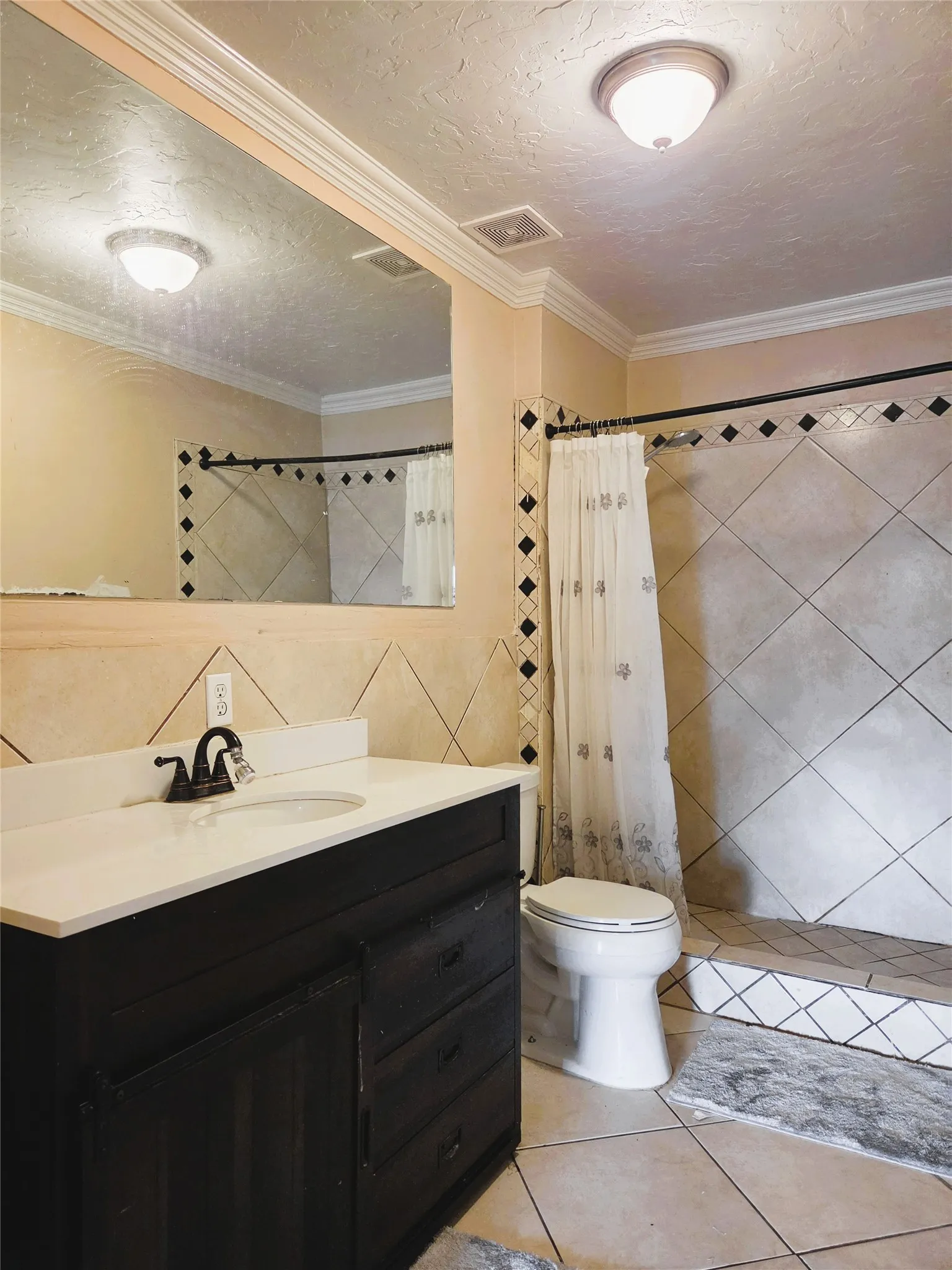 Bathroom featuring a dark wood-finish vanity with a white countertop and integrated sink