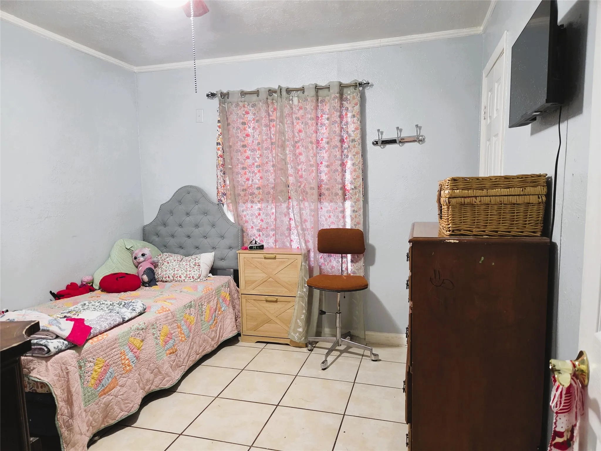 Room featuring tile flooring, light-colored walls, and a ceiling fan