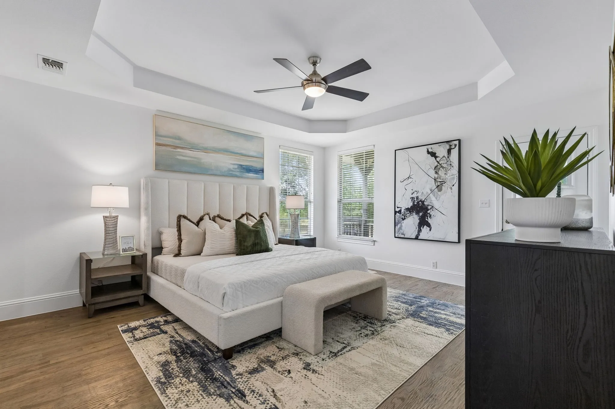 Large primary bedroom with tray ceiling