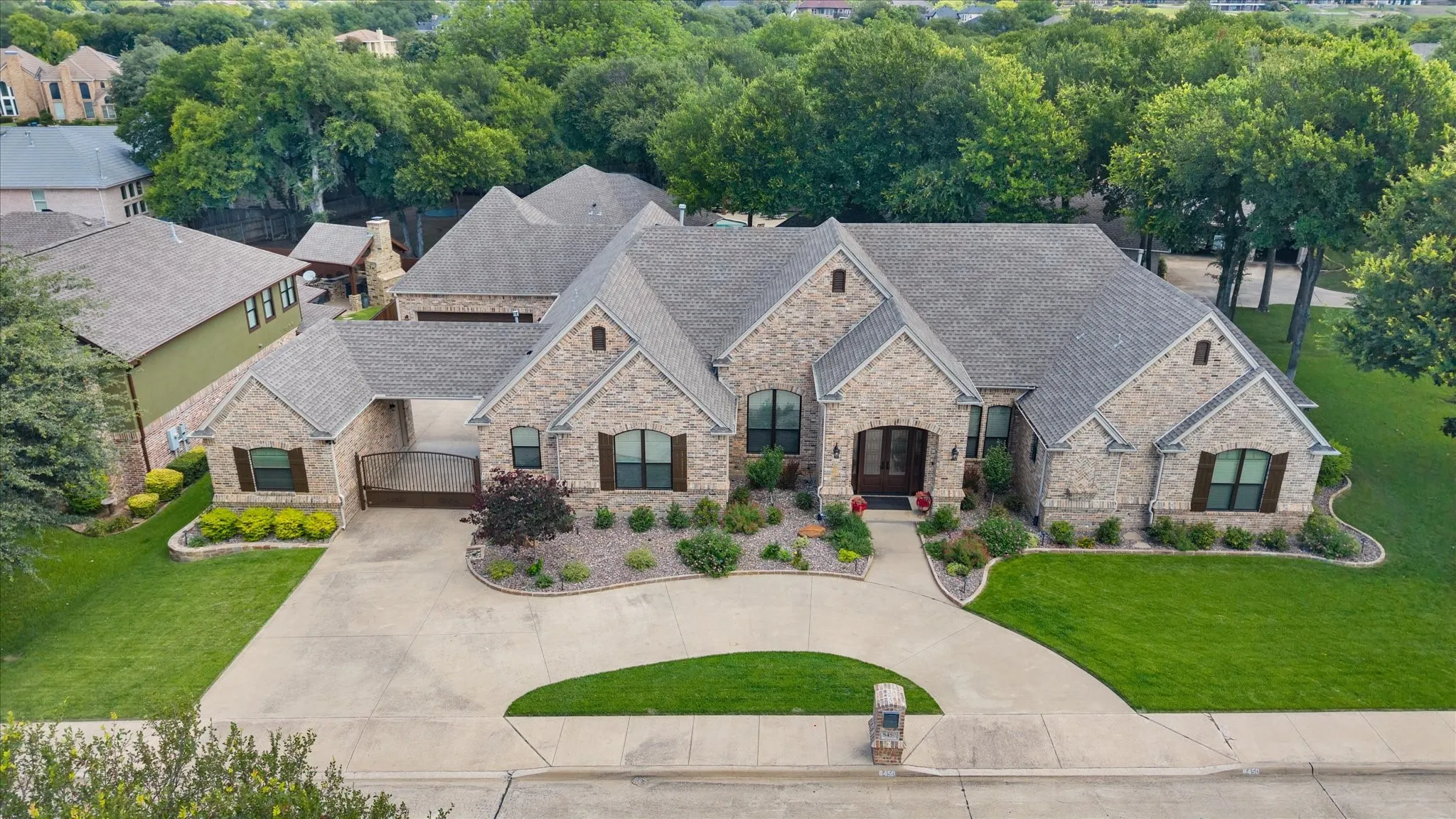 Stone exterior residence featuring a multi-gabled roofline and an arched entryway