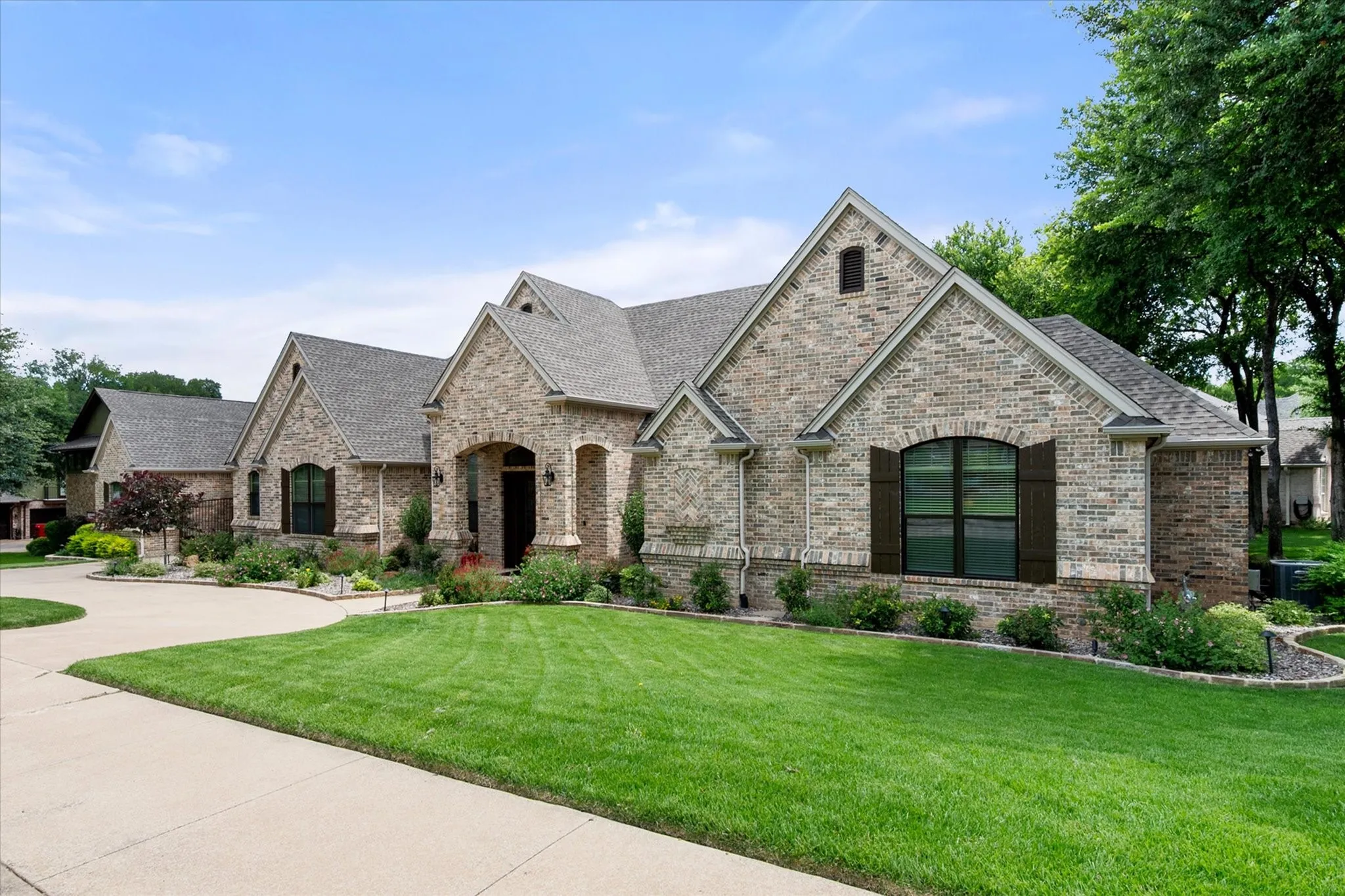 Brick exterior residence with multiple gables and a covered front entry