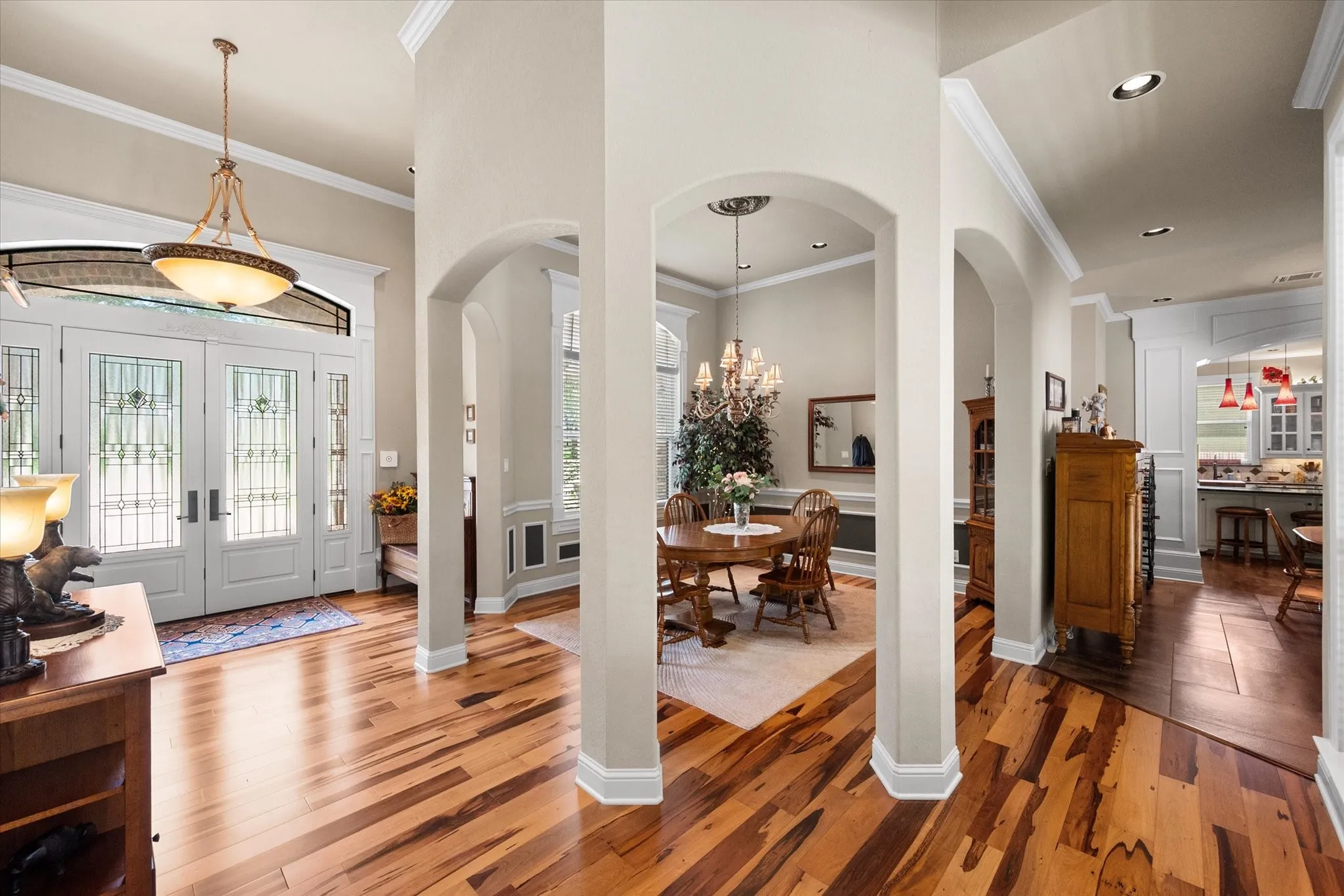 Inviting entryway featuring double doors with decorative glass panels and transom window