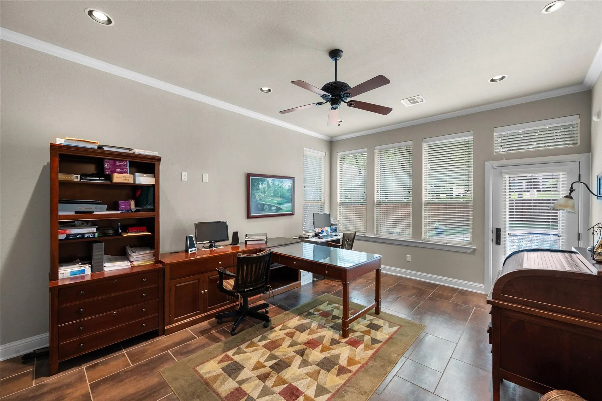 Spacious room featuring wood-finish flooring, recessed lighting, and a ceiling fan