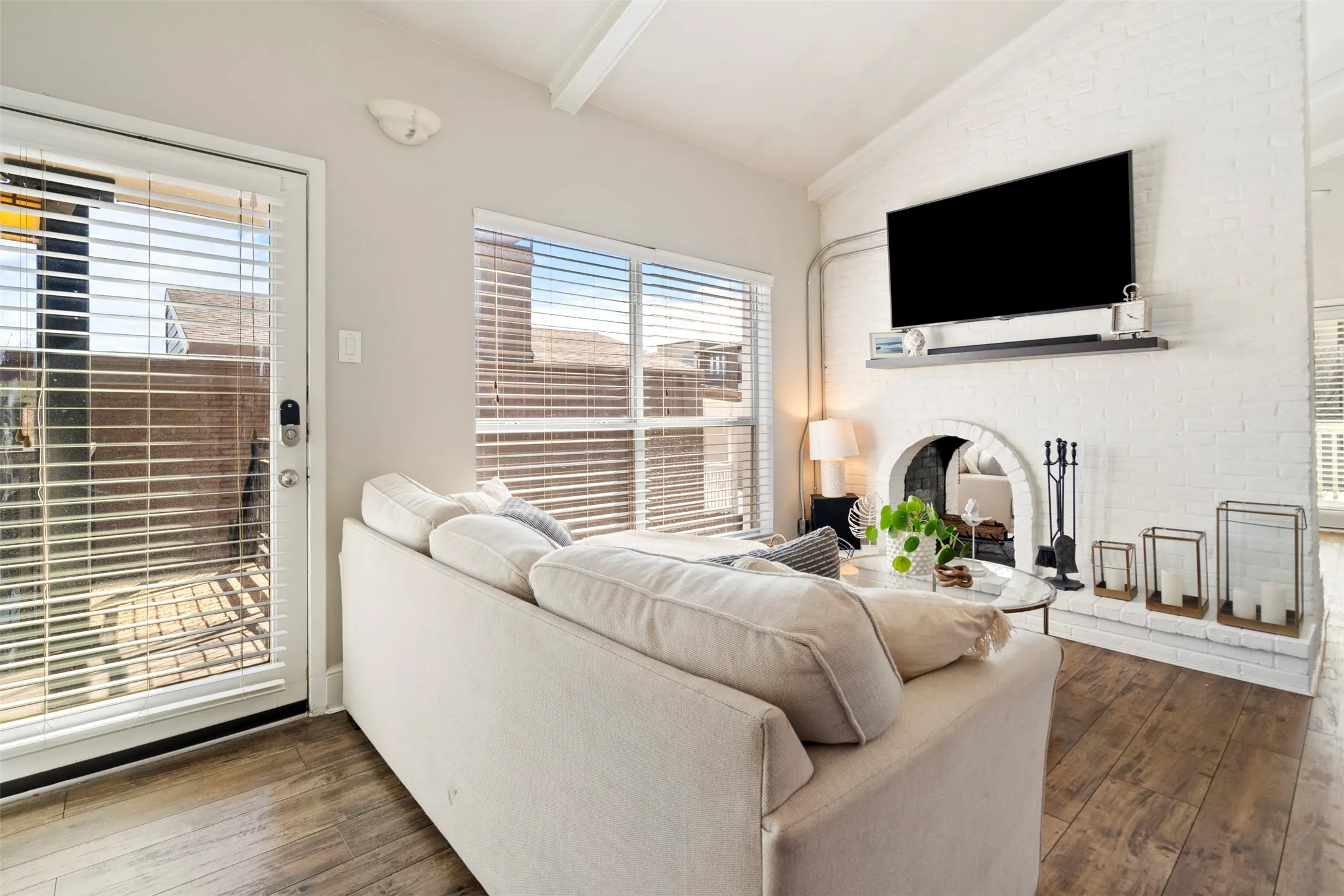 Great view of the living area with see through fireplace with mantel and hearth.