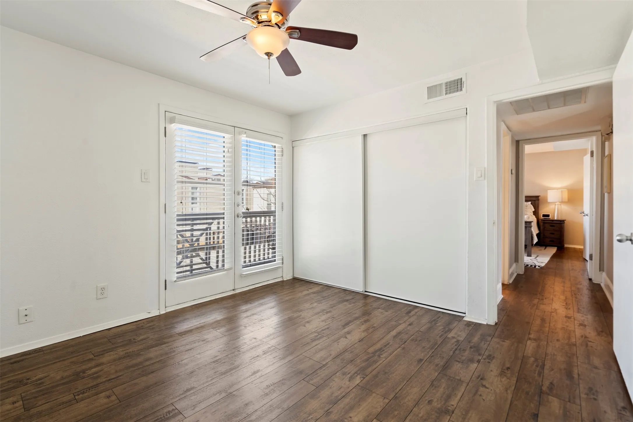 Guest Bedroom almost same size as the primary bedroom with spacious closet spanning the one wall with sliding doors.