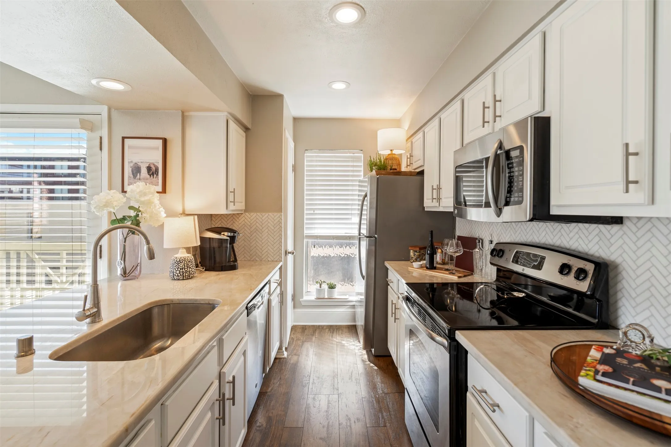 Owner updated to add canned lighting, stainless steel farm sink plus sink and cabinet fixtures.