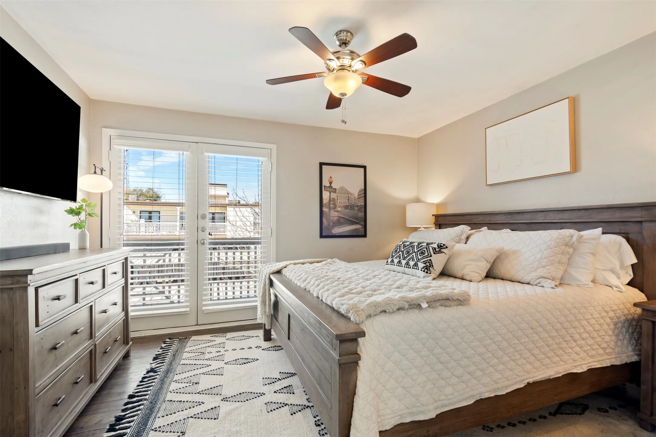 Spacious Primary En Suite currently shown with King Size Bed with two end tables, large dresser and flat screen.