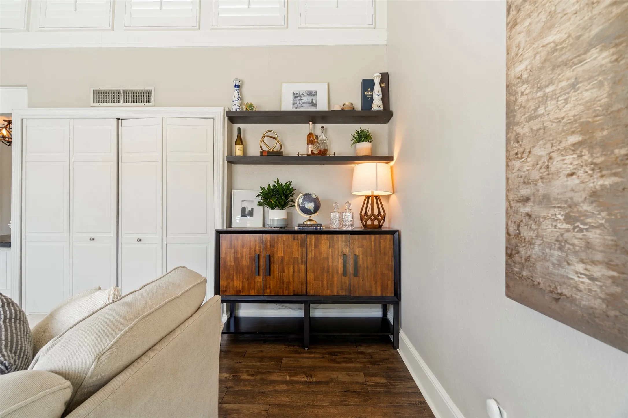 Interior Entry Area with little bit of a view of the transom windows with Plantation Windows that span through the entertaining areas for living and dining.