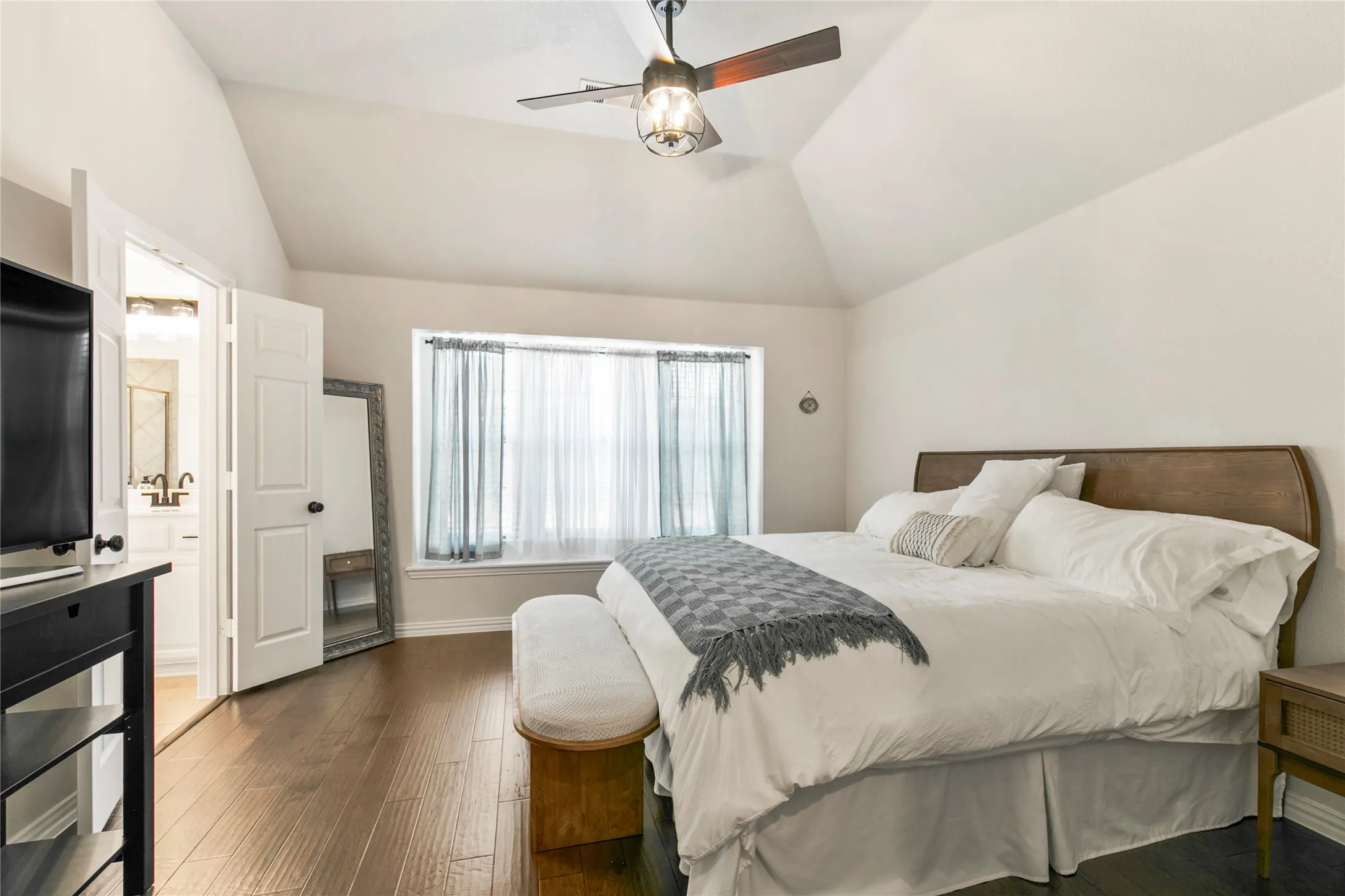 Room featuring vaulted ceilings and dark wood-finish flooring